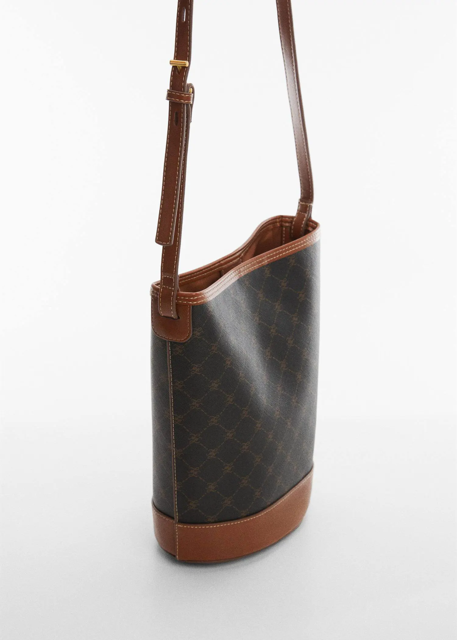 Mango Bucket bag with printed logo. a close-up of the side of a brown and black purse. 