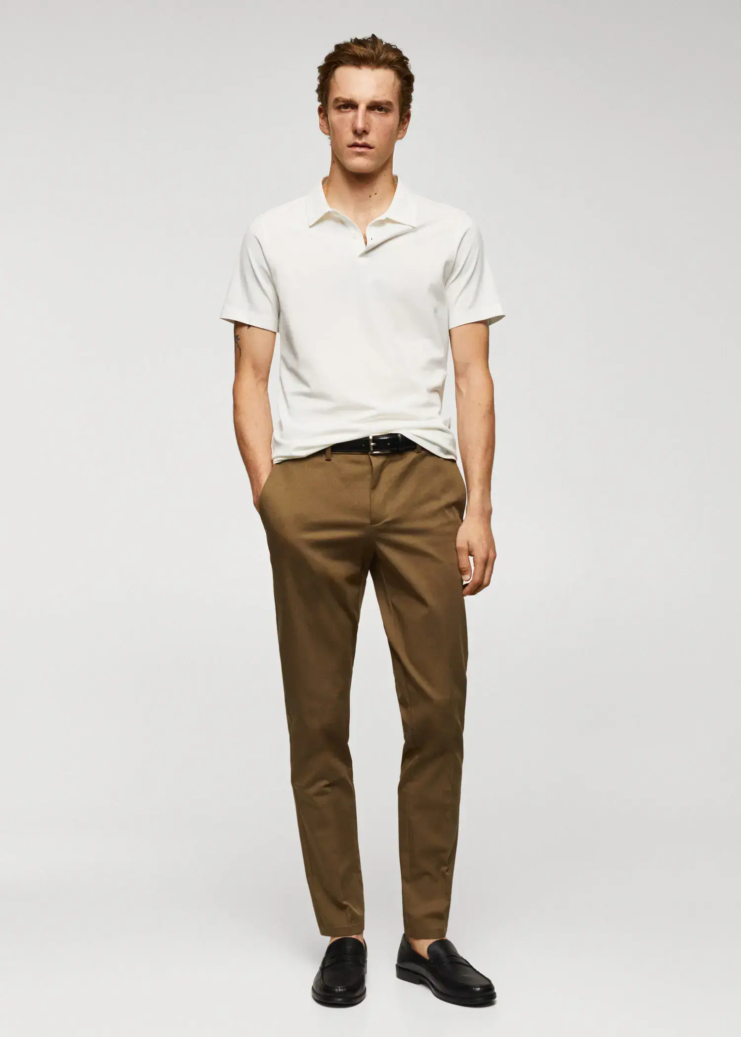 Mango Slim-fit textured cotton polo shirt. a man wearing a white shirt and brown pants. 