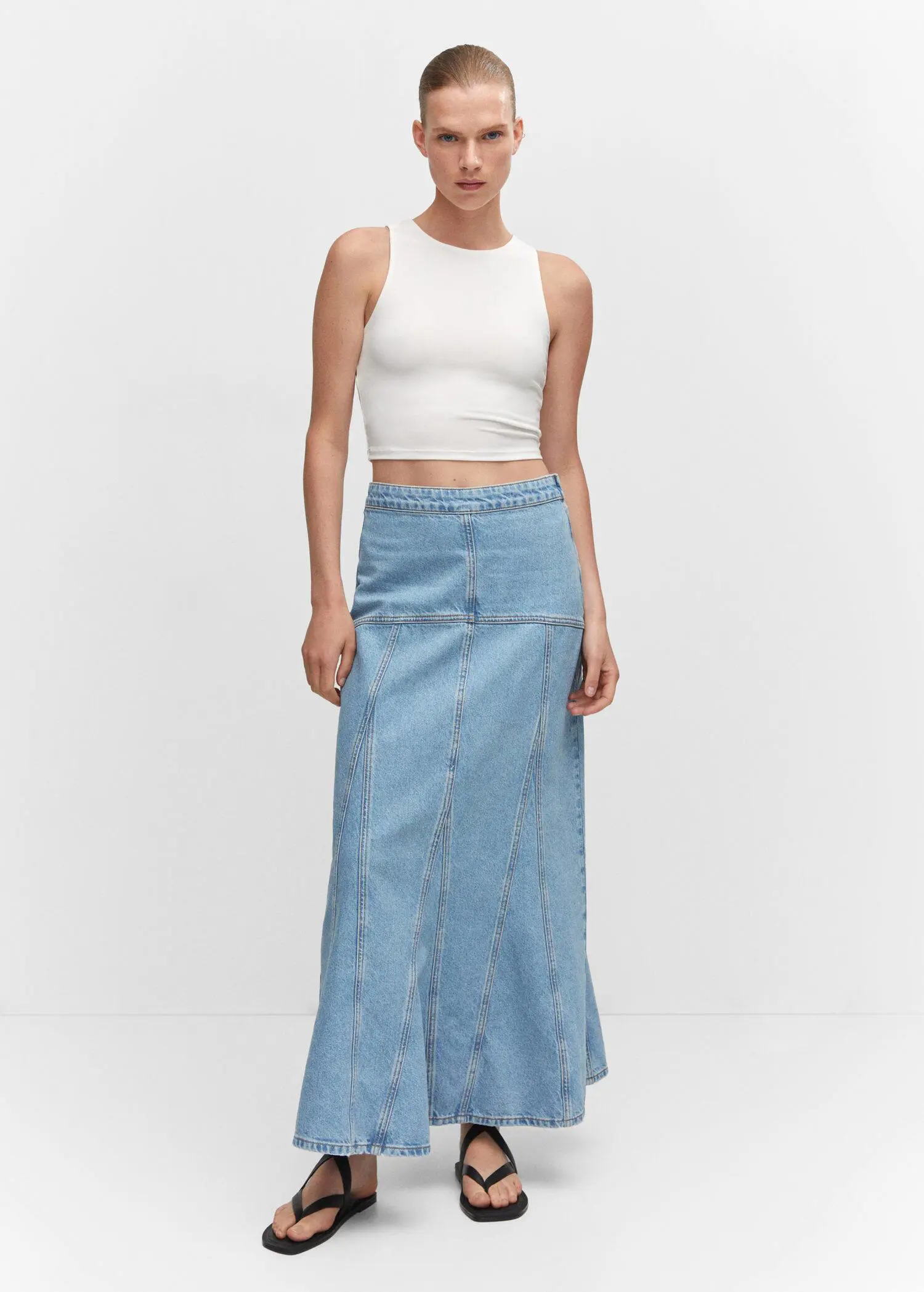 Mango Long denim skirt with seams. a woman wearing a white top and a long skirt. 