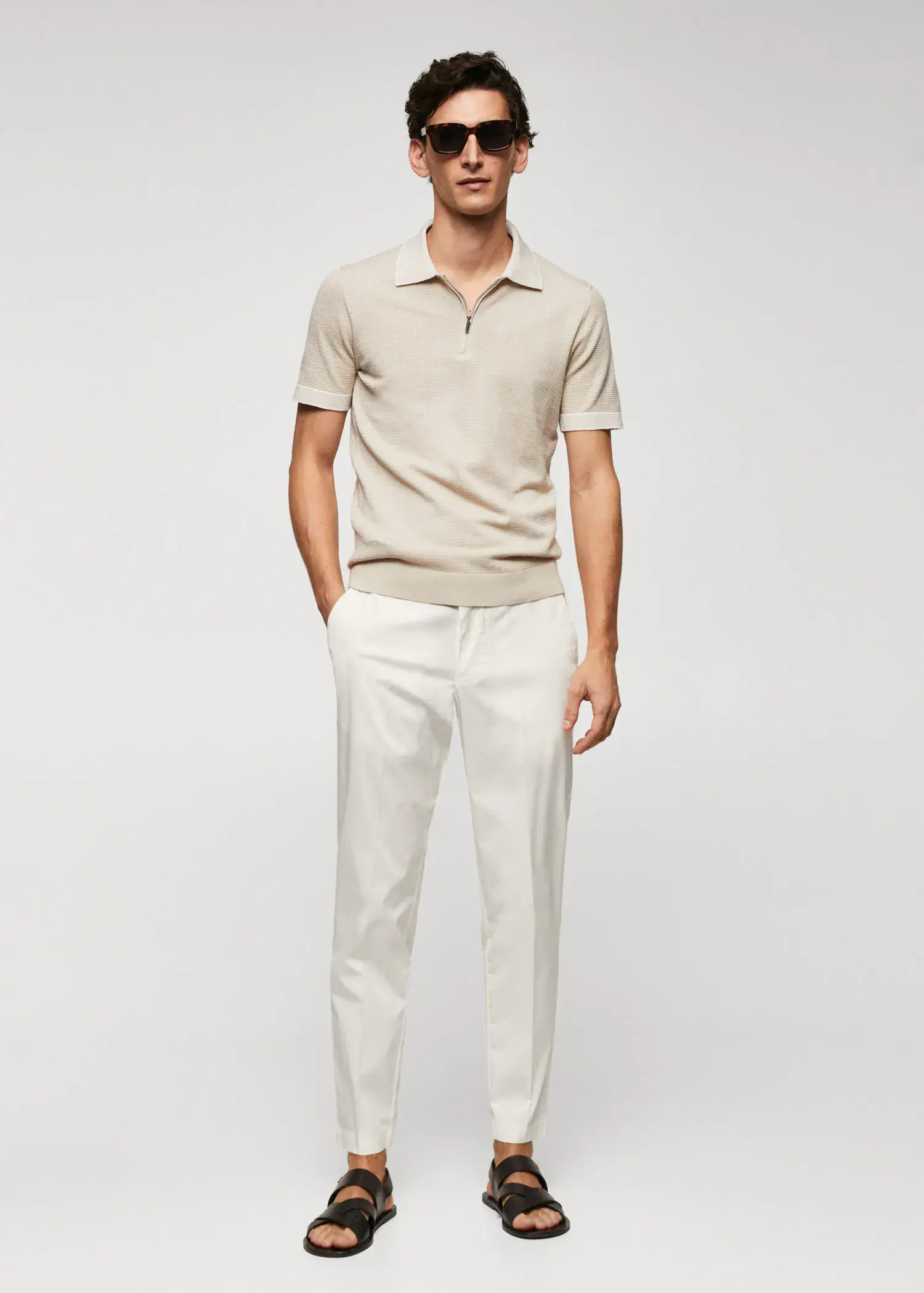 Mango Fine-knit polo shirt with zip. a man in a beige polo shirt and white pants. 