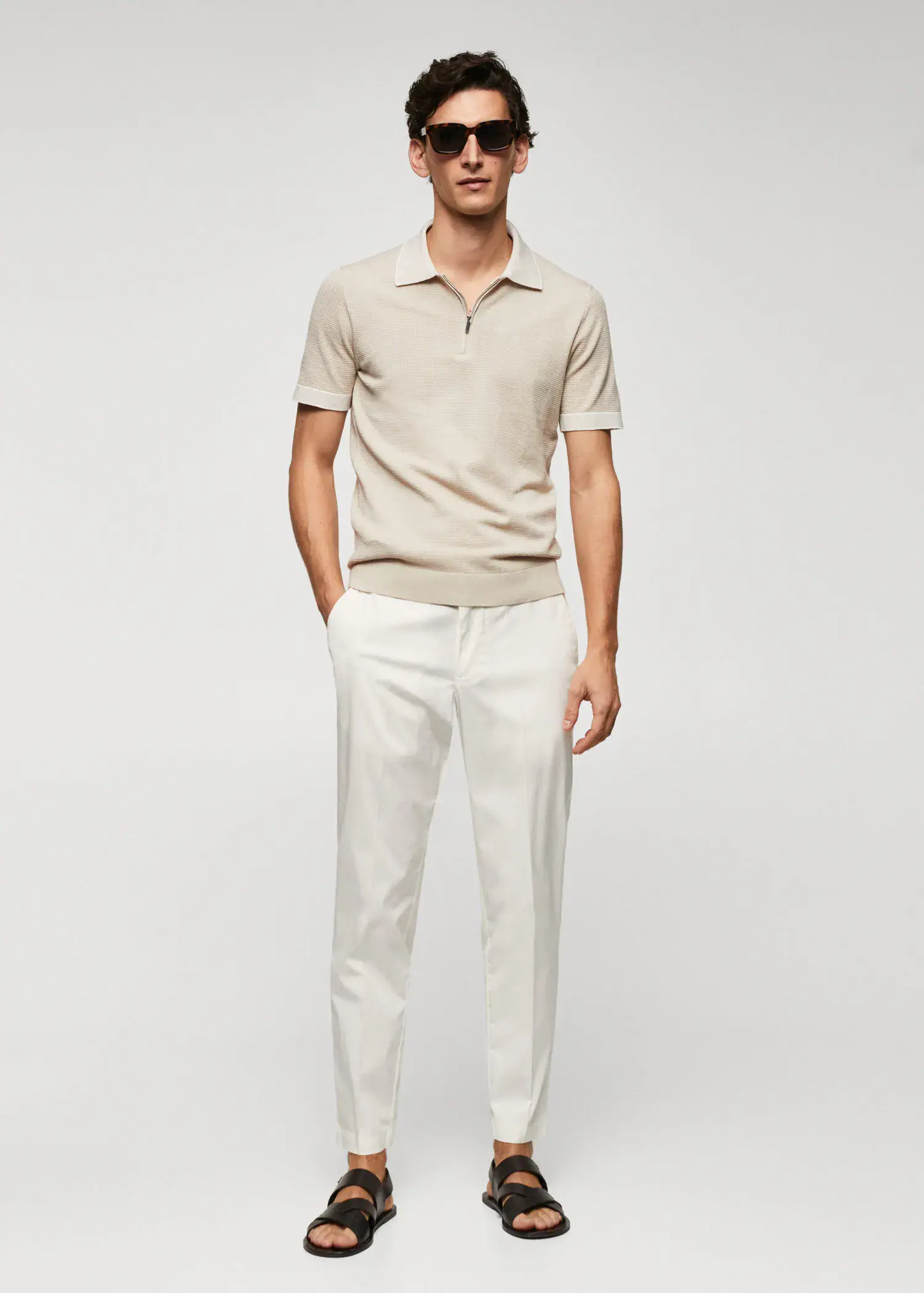 Mango Fine-knit polo shirt with zipper. a man in a beige polo shirt and white pants. 