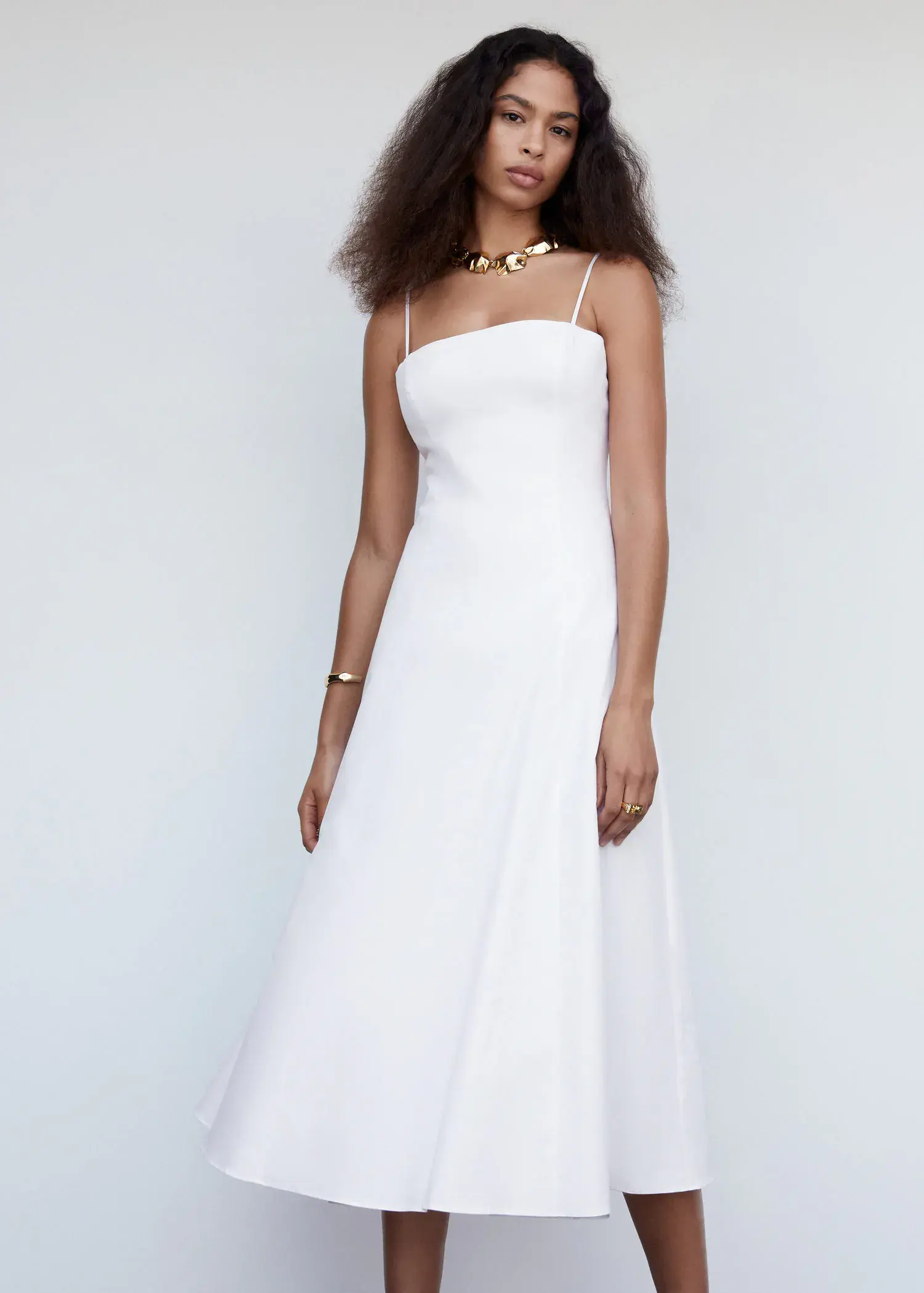 Mango Midi-dress with back detail. a woman in a white dress standing in front of a white wall. 