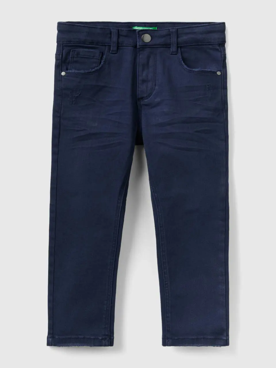 Benetton jeans with small rips. 1