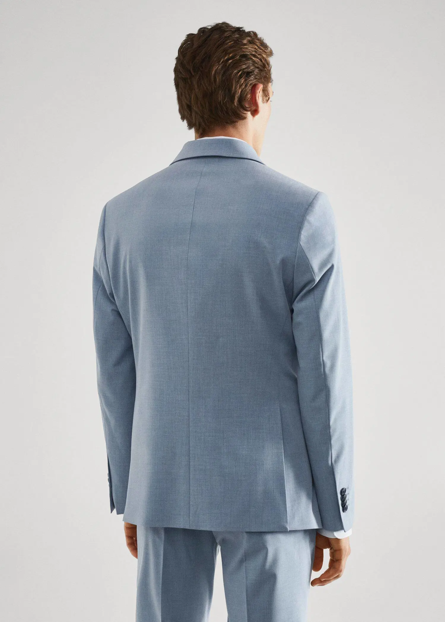 Mango Stretch fabric slim-fit suit jacket. a man wearing a light blue suit jacket. 