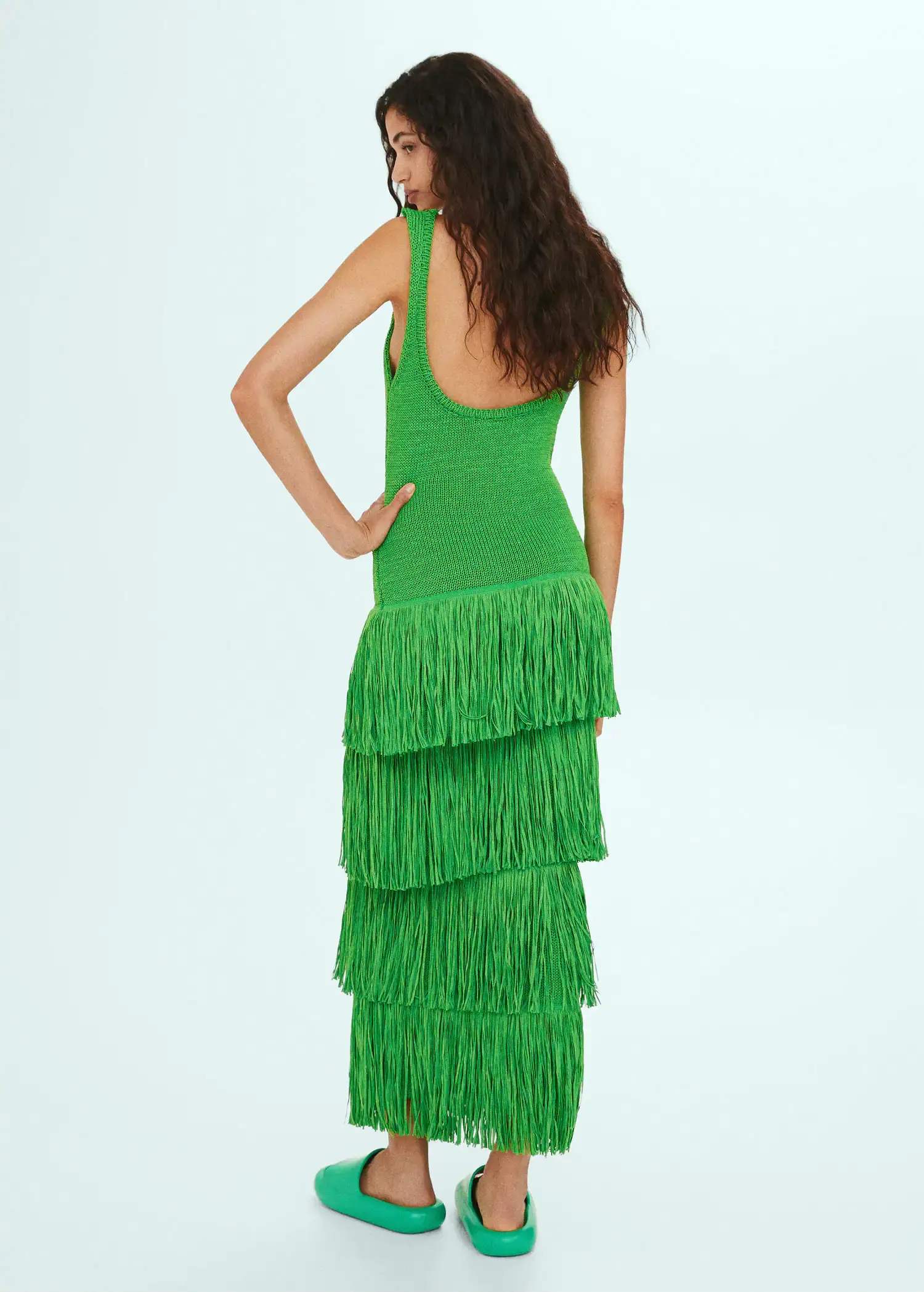 Mango Knitted dress with fringe design. a woman wearing a green dress with fringes. 