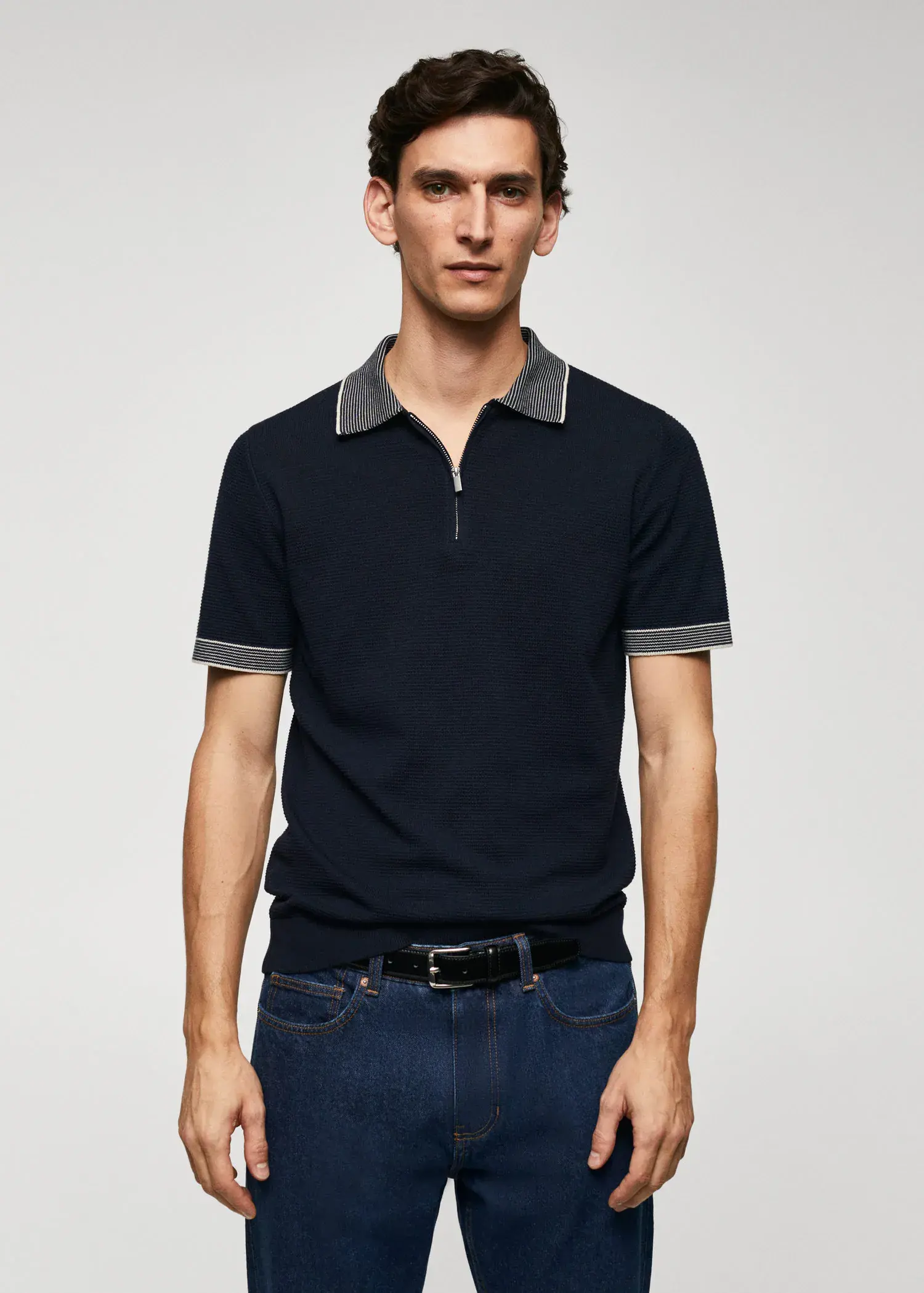 Mango Fine-knit polo shirt with zip. a young man wearing a black polo shirt and jeans. 