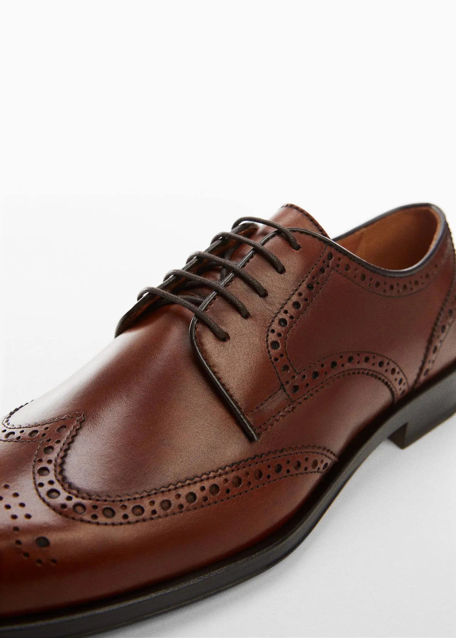 Mango Die-cut leather dress shoes. a close-up of a pair of brown leather shoes. 