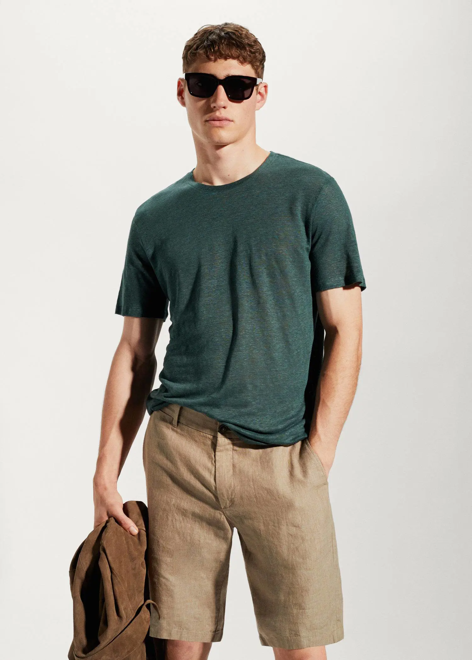 Mango 100% linen slim-fit t-shirt. a young man wearing sunglasses and a green tee shirt. 