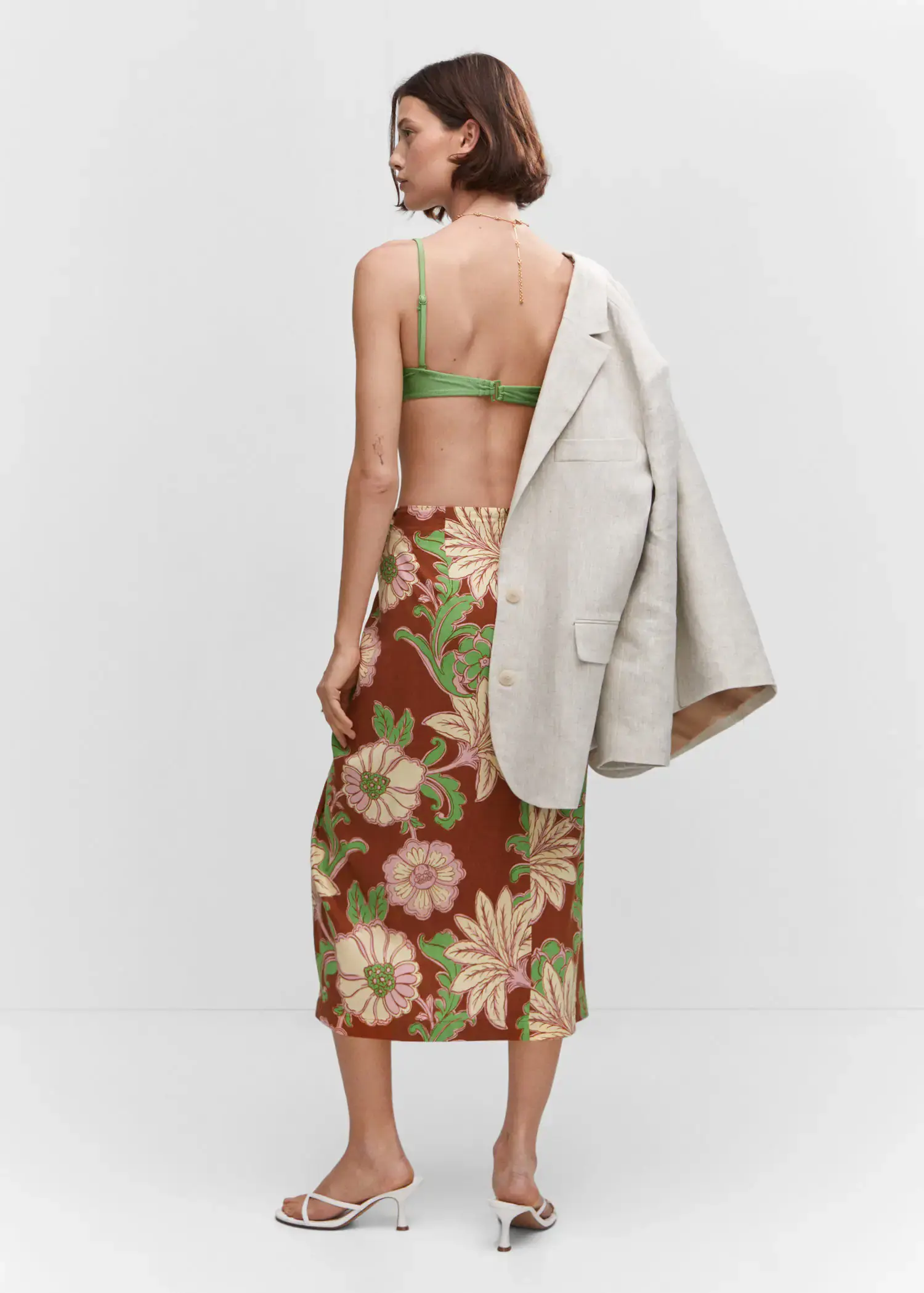 Mango Knot printed skirt. a woman wearing a floral skirt and a jacket. 