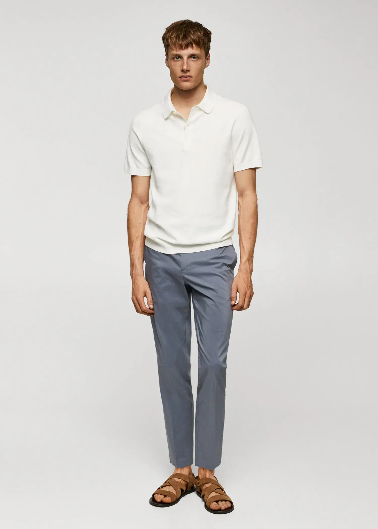 Mango Fine-knit polo shirt. a man in a white shirt and blue pants. 