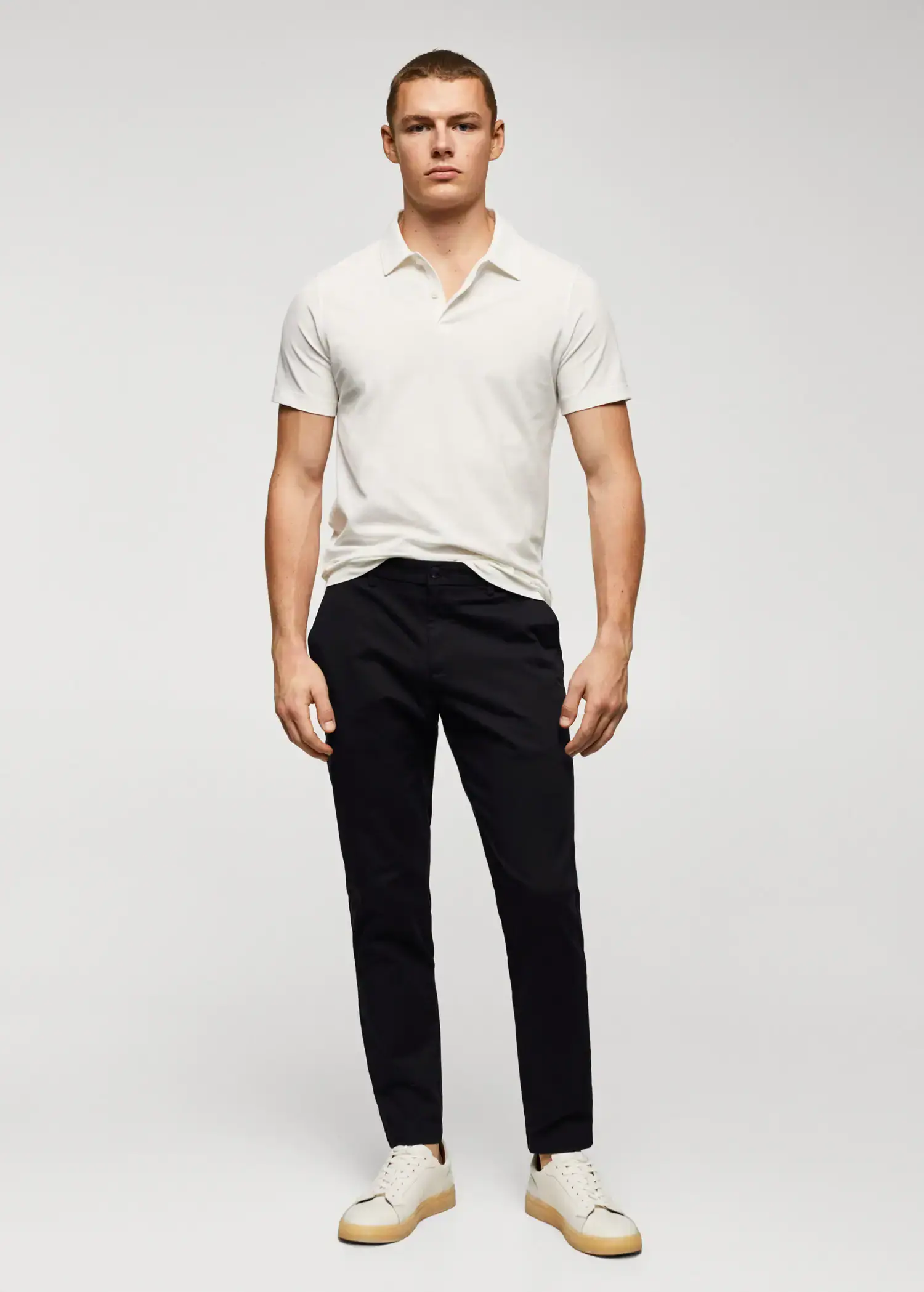 Mango Cotton tapered crop pants. a man wearing a white shirt and black pants. 