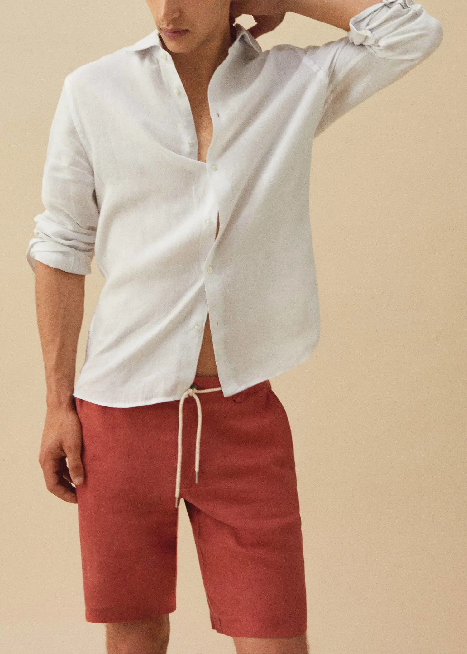 Mango 100% linen bermuda shorts with drawstring. a man in a white shirt and red pants. 
