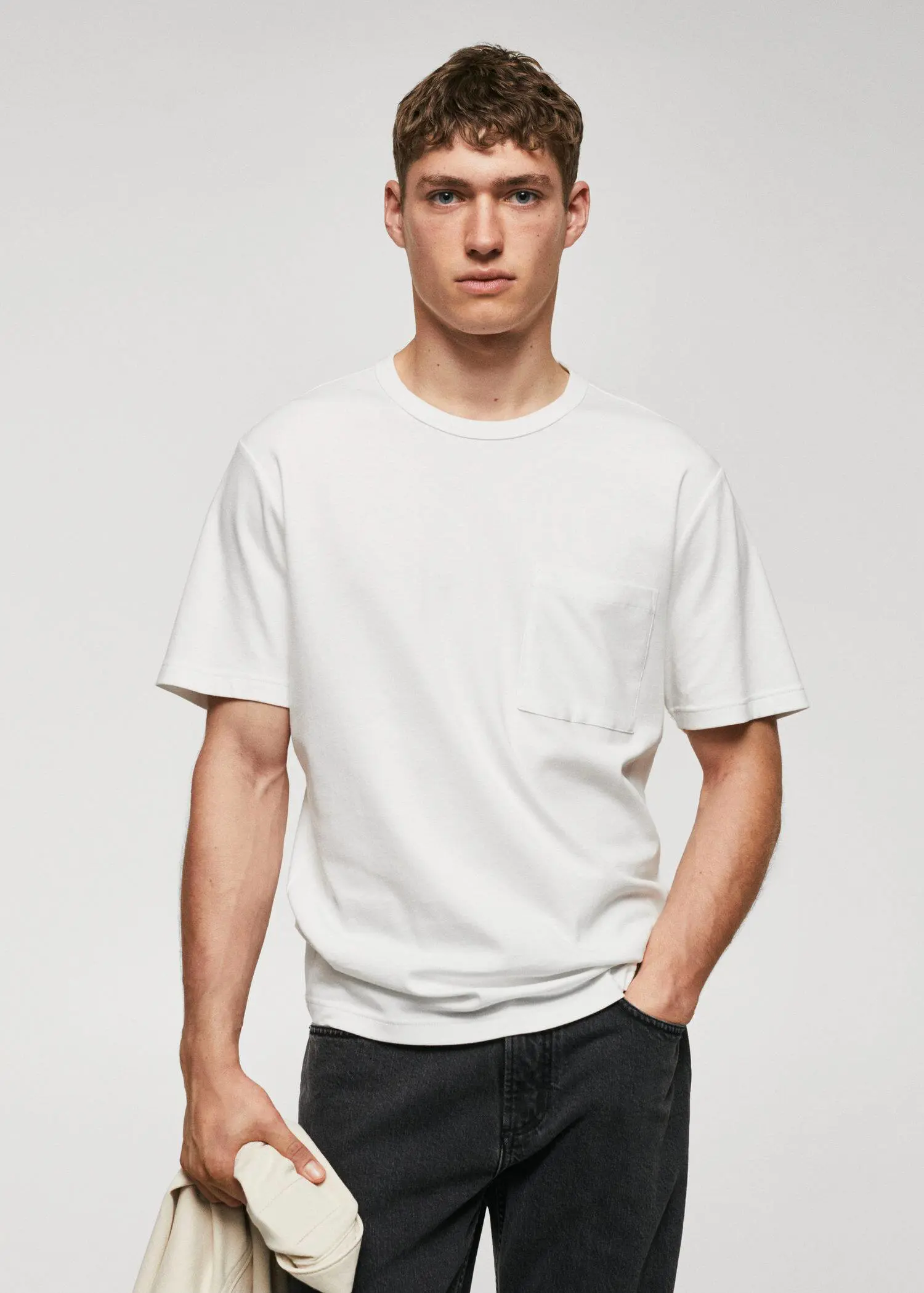Mango 100% cotton t-shirt with pocket. a man wearing a white t-shirt and black jeans. 