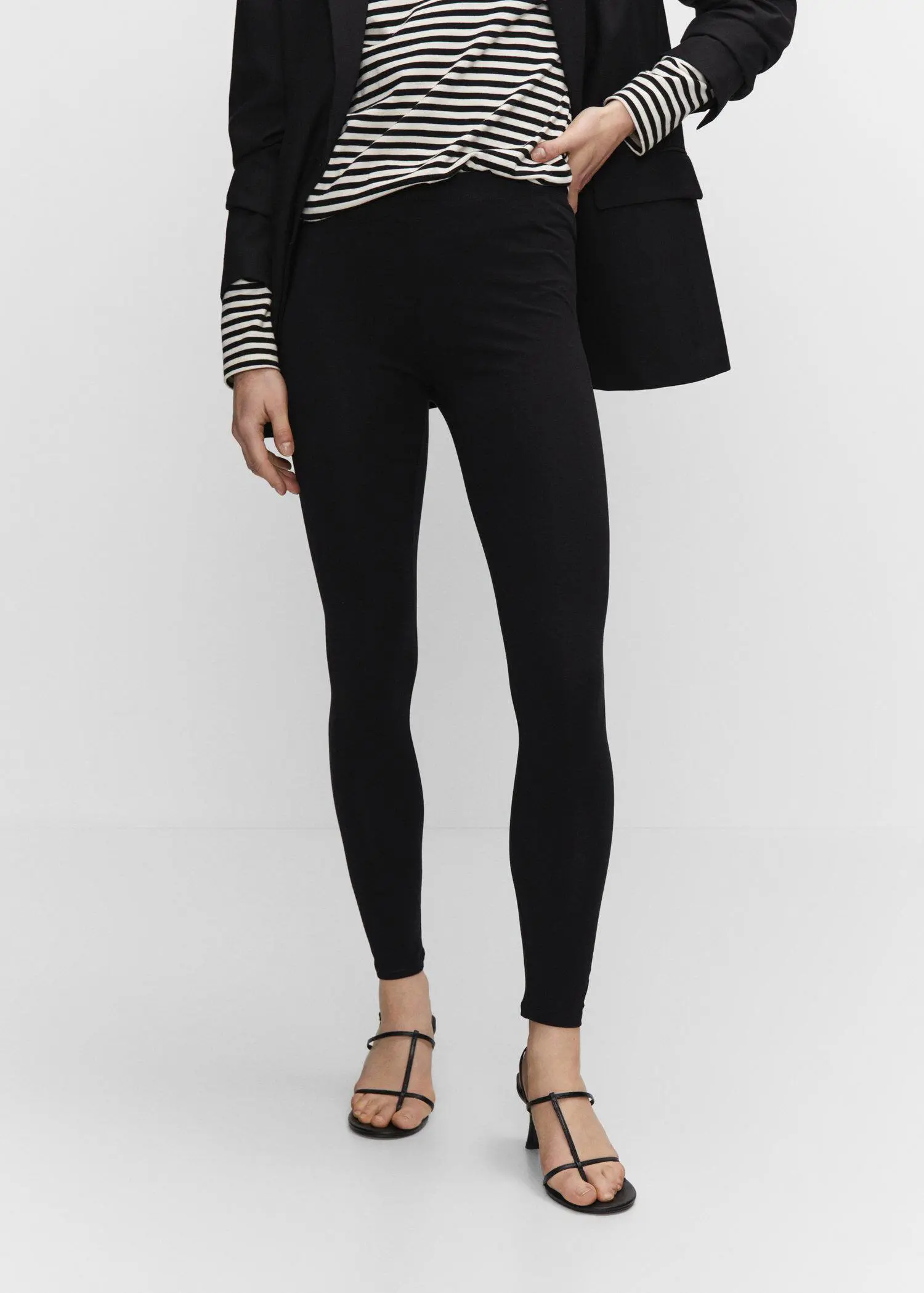 Mango High waist cotton leggings. a woman in black pants and a jacket. 