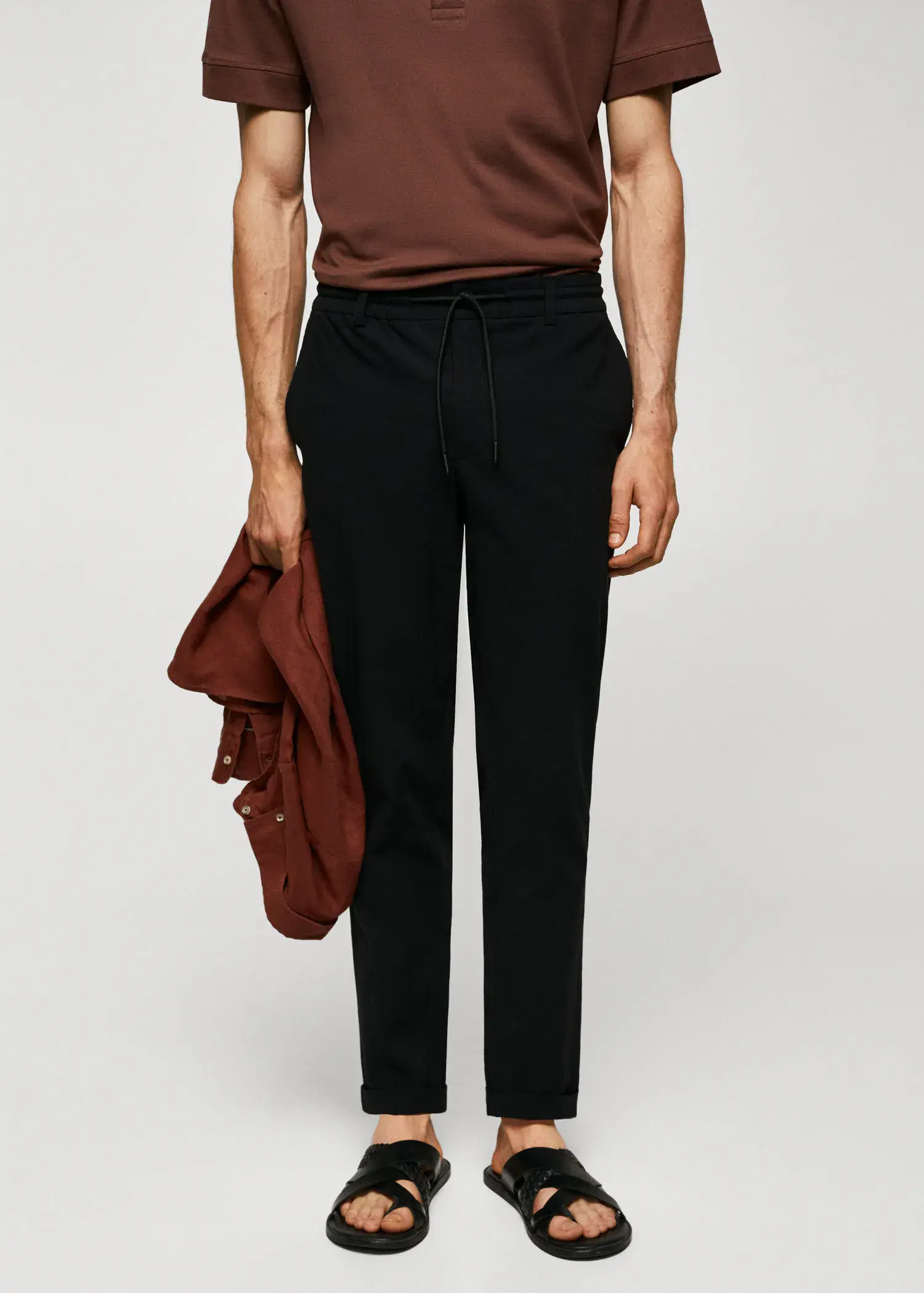 Mango Cotton seersucker trousers with drawstring . a man wearing black pants and a brown shirt. 