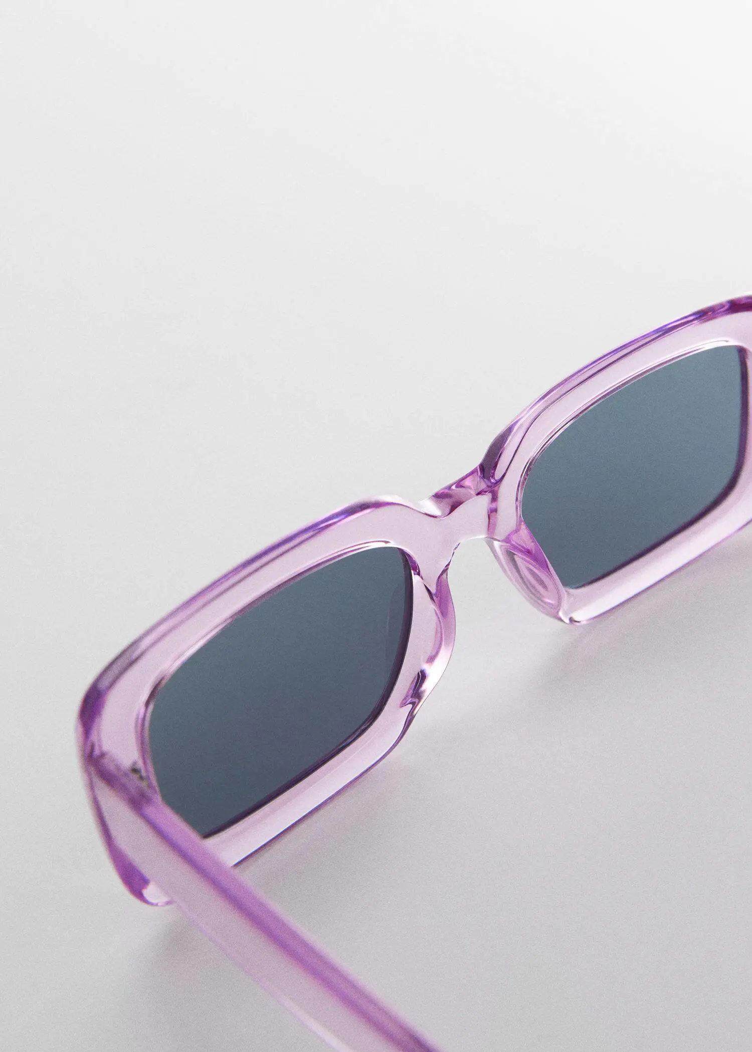 Mango Rectangular sunglasses. a close up of a pair of pink sunglasses 