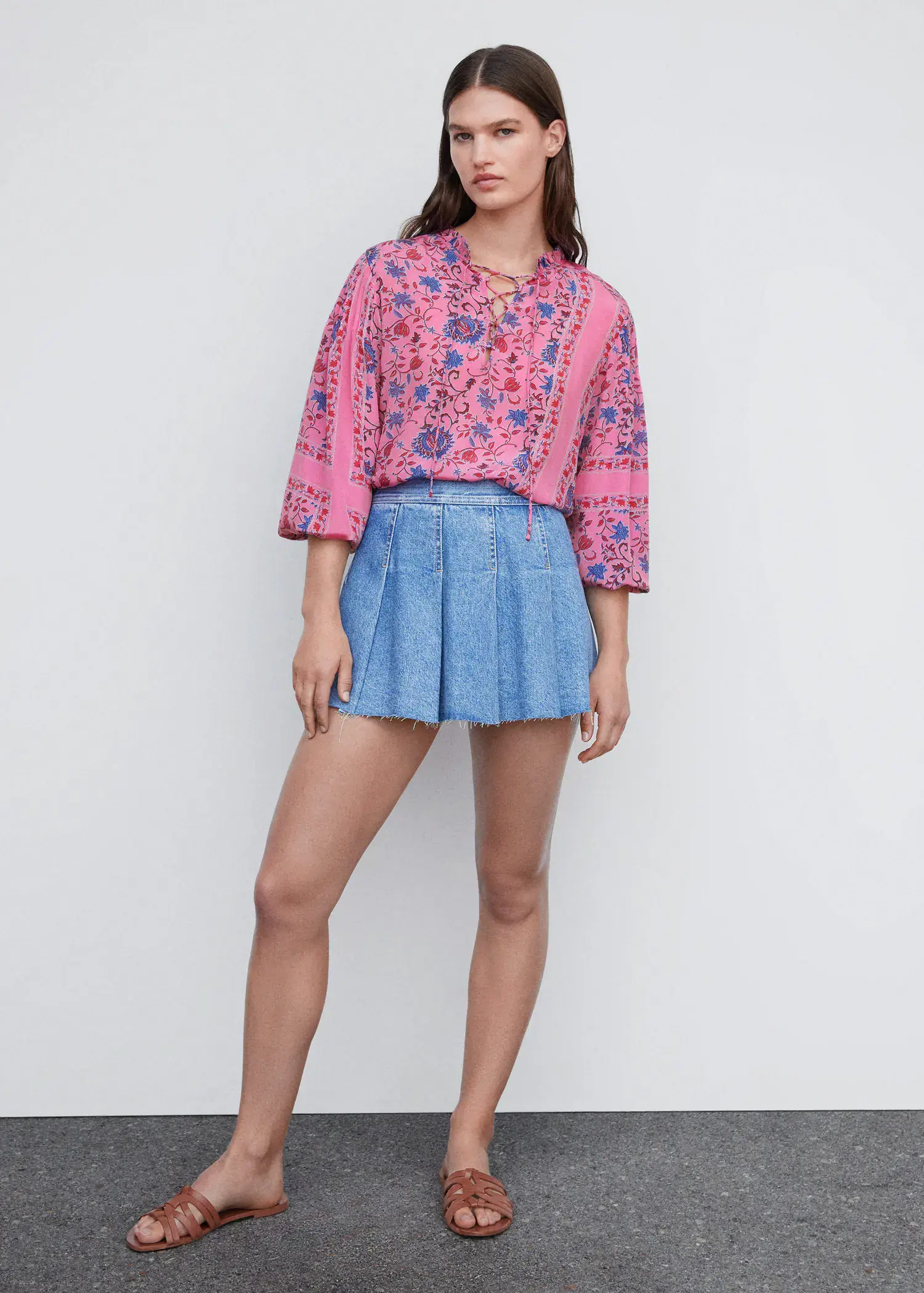 Mango Printed puff sleeve blouse. a woman in a pink shirt and blue skirt. 