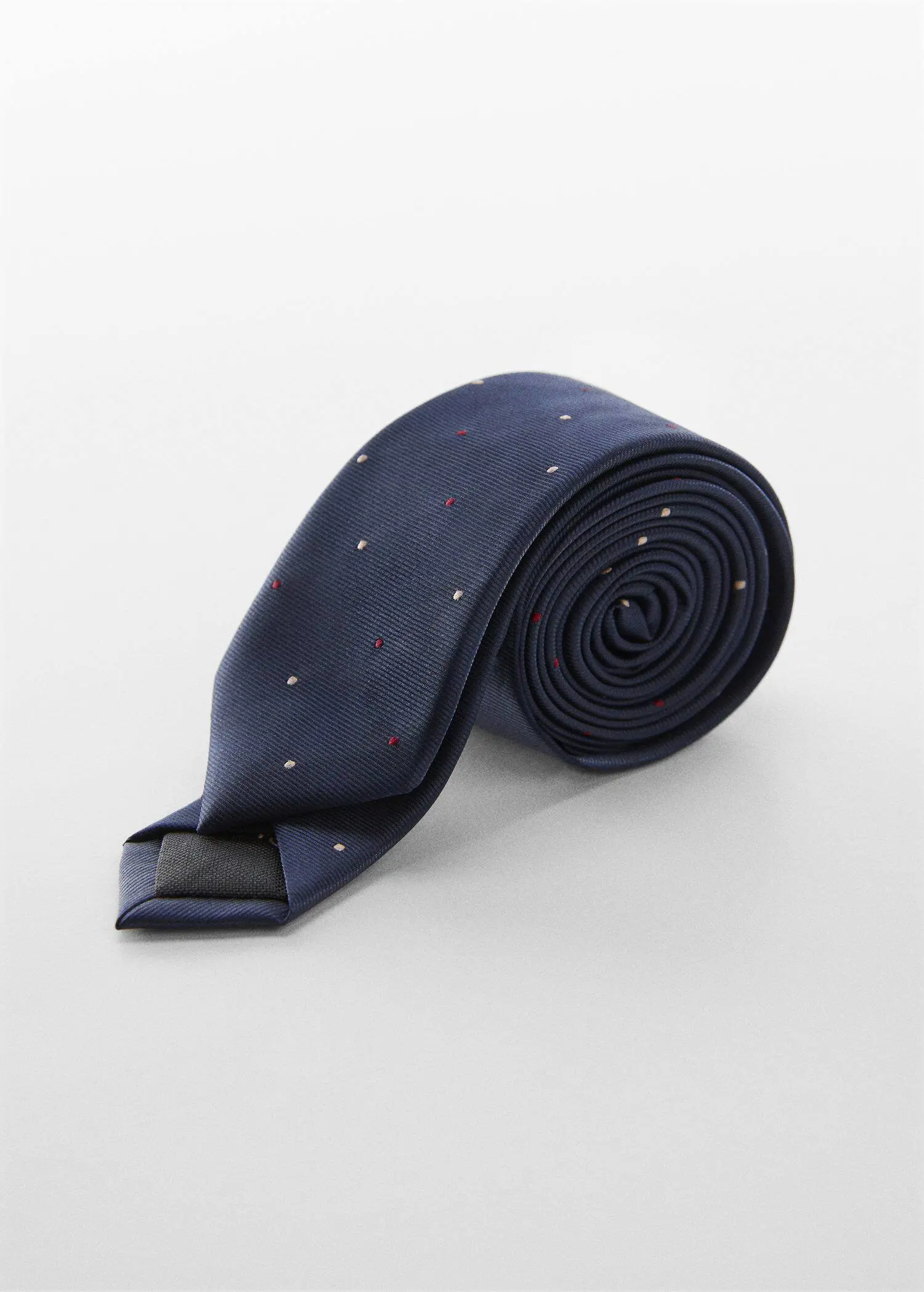 Mango Tie with micro polka-dot structure. a blue tie with red and white polka dots. 