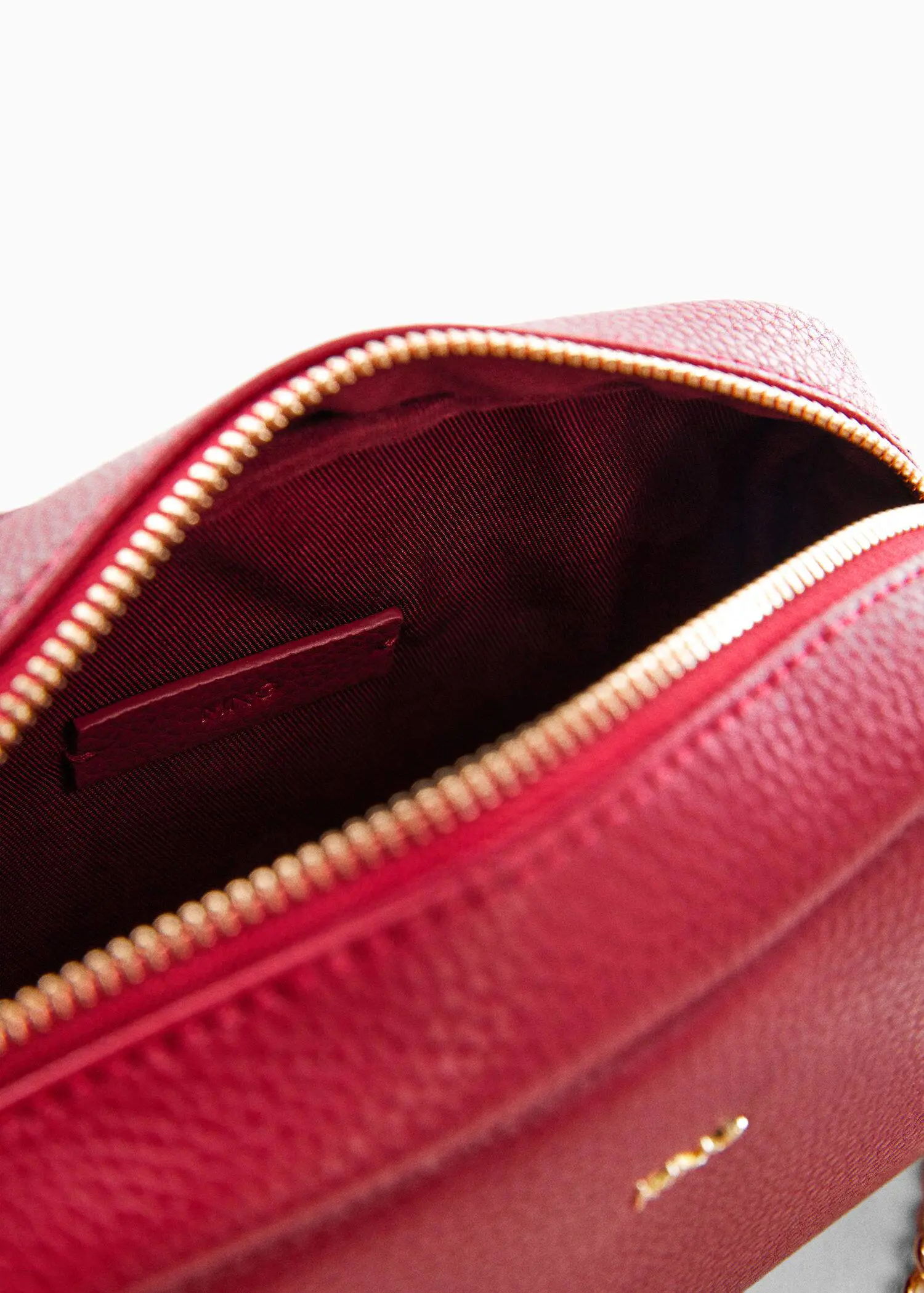 Mango Crossbody bag with chain. a close-up view of the inside of a red purse. 