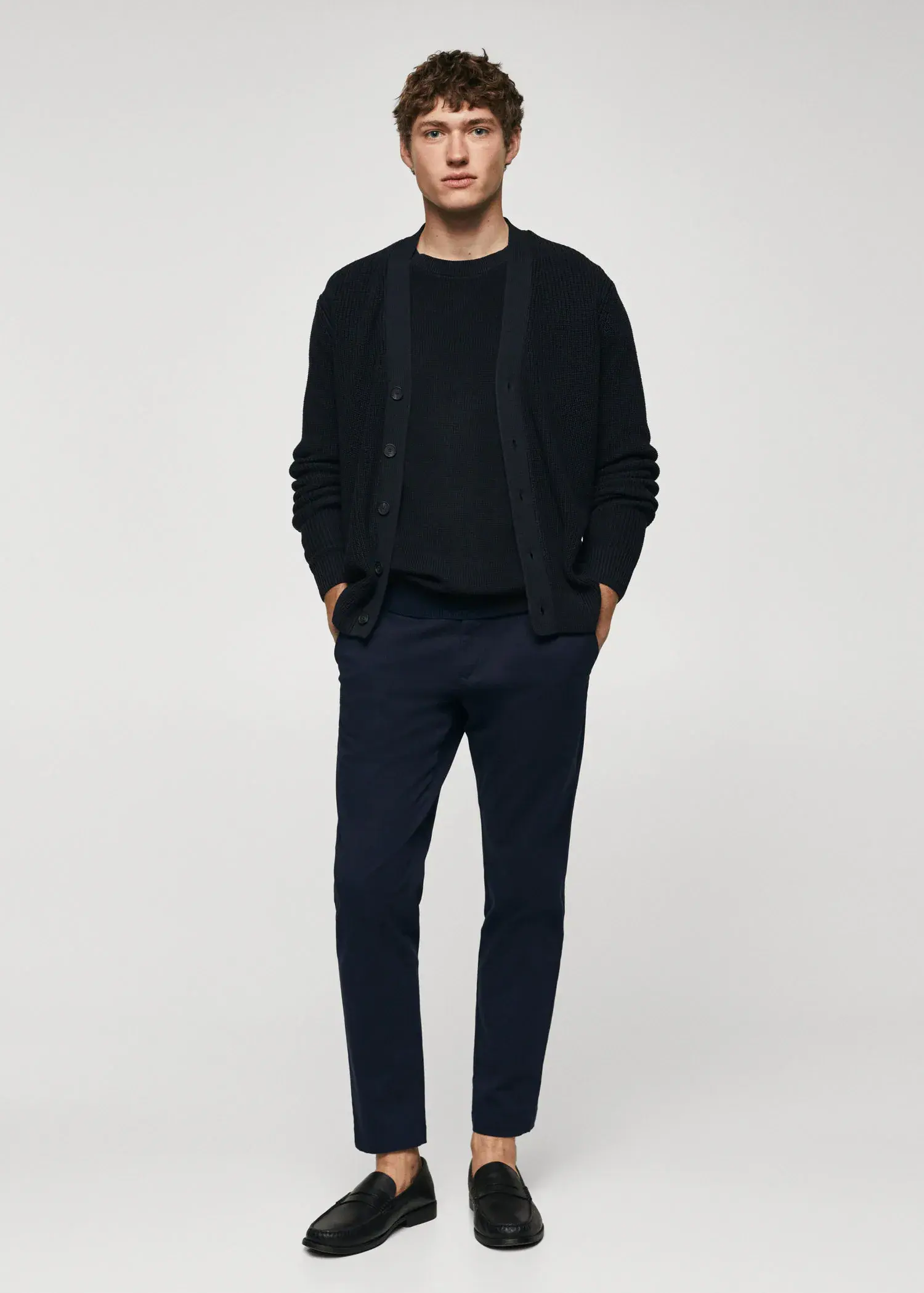 Mango Cotton tapered crop pants. a man wearing a black sweater and black pants. 