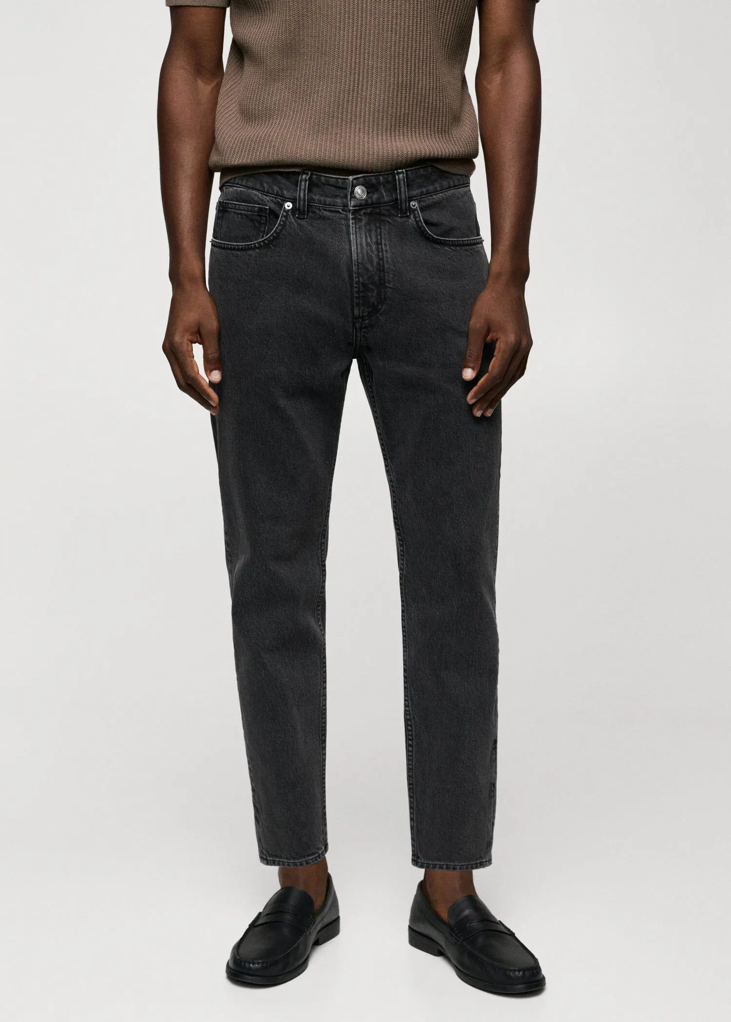 Mango Ben tapered cropped jeans. a man wearing a pair of black jeans. 