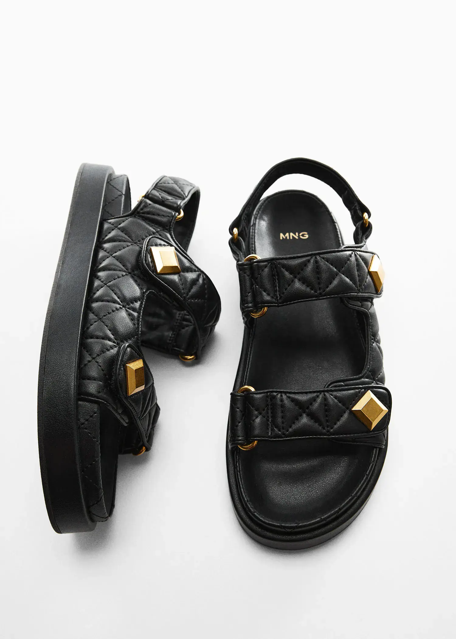 Mango Velcro padded sandal. a pair of black sandals with gold hardware. 