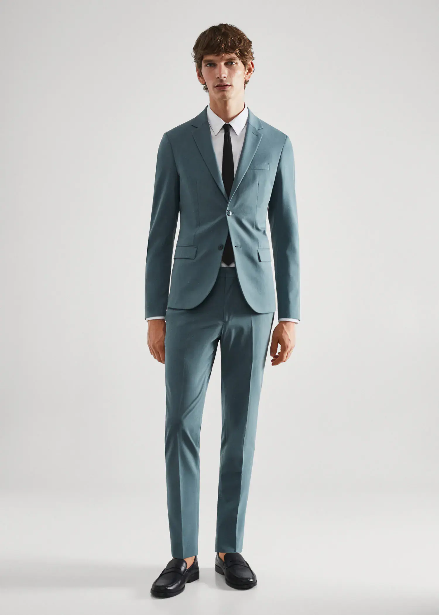 Mango Super slim-fit suit jacket in stretch fabric. a man wearing a suit and tie standing in a room. 