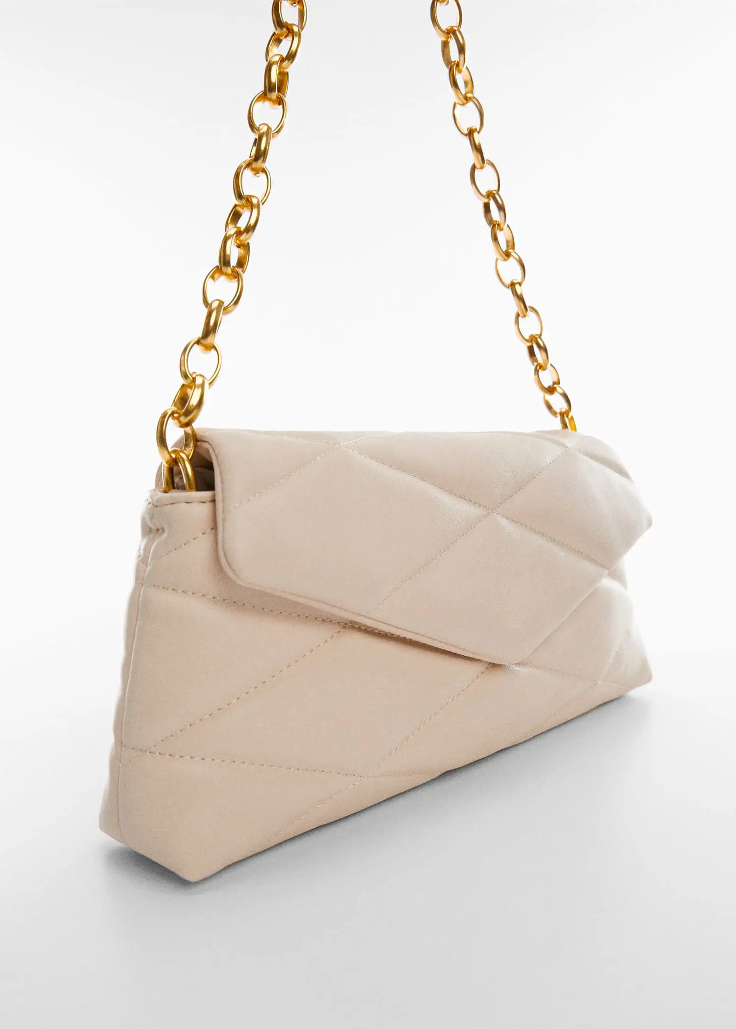 Mango Quilted bag with chain handle. a white purse with a gold chain on a white surface. 