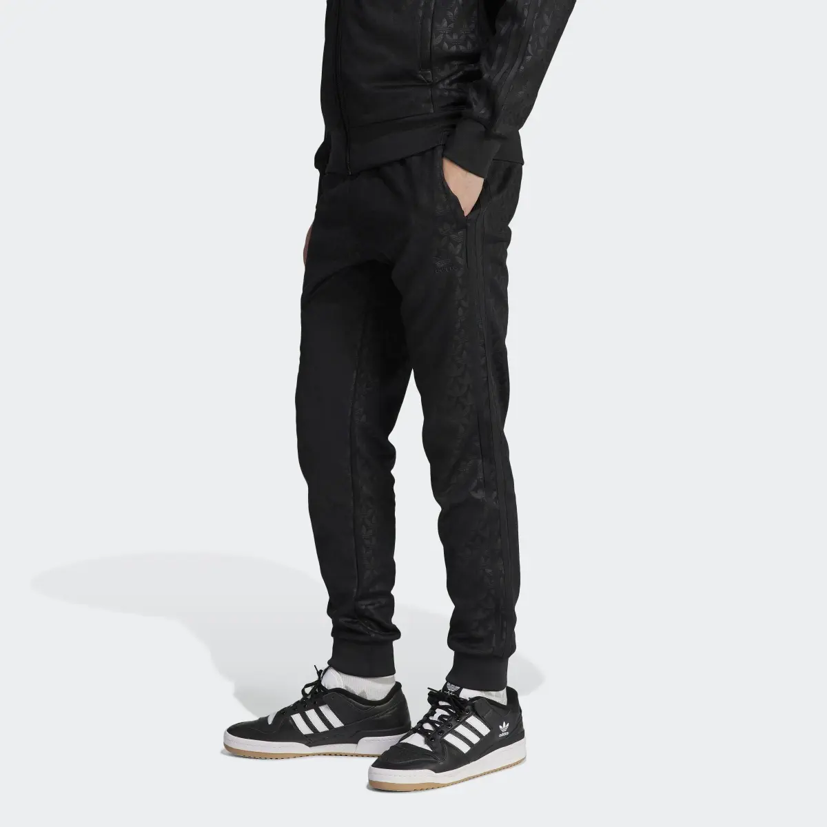 Adidas Adicolor Graphics Monogram SST Track Pants. 1