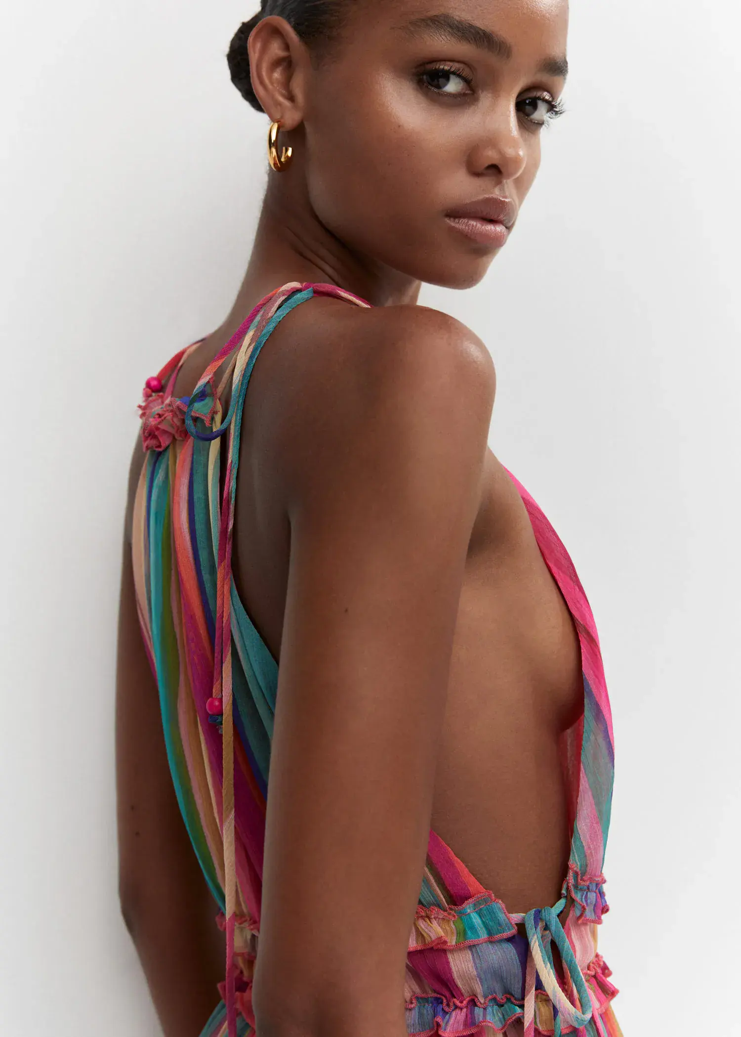 Mango Hoop earrings. a young woman wearing a multicolored dress. 