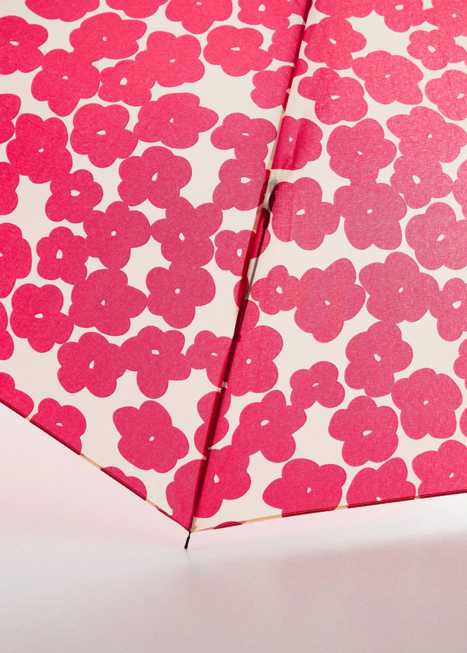 Mango Floral folding umbrella. a close-up view of a pink floral umbrella. 