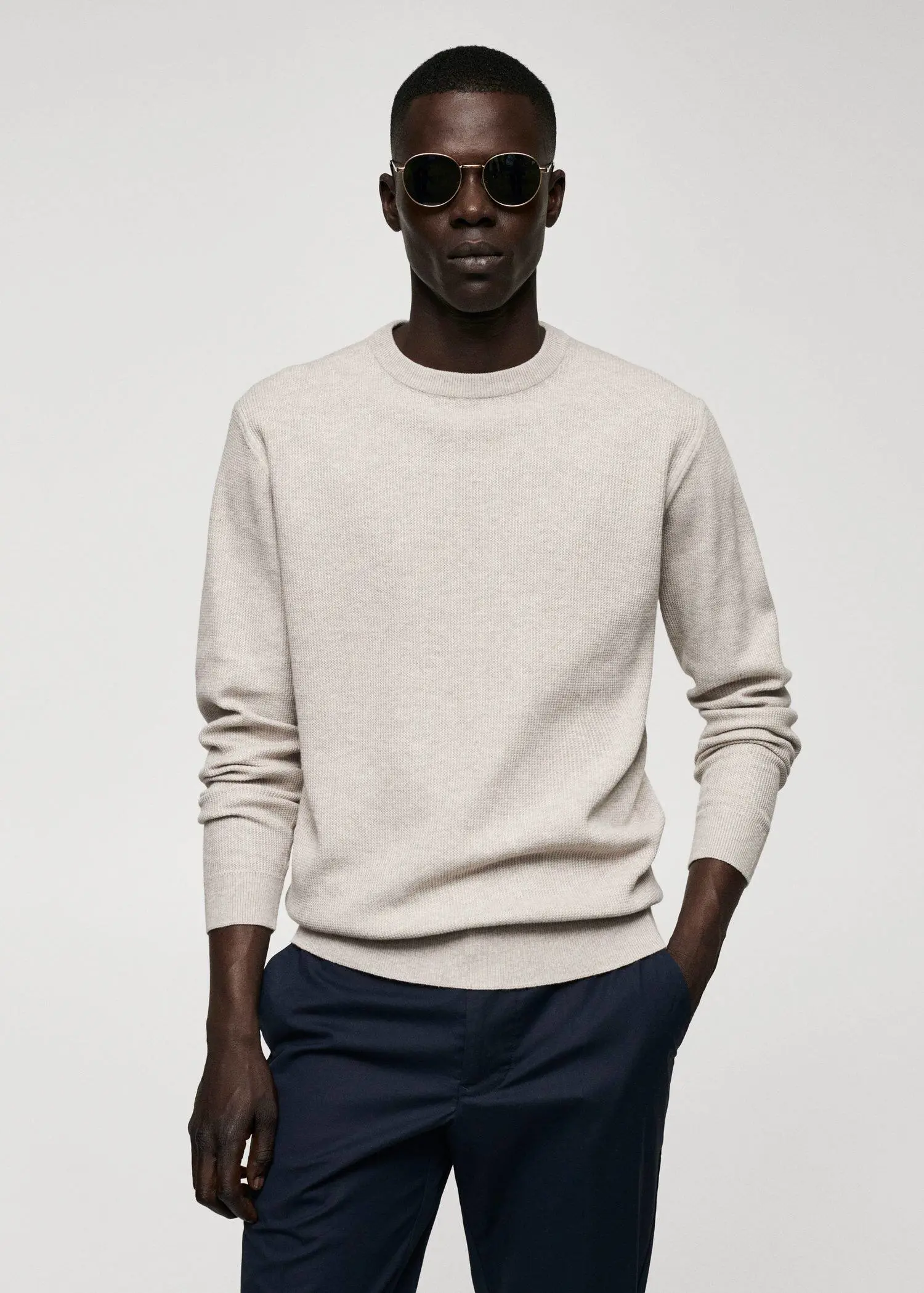Mango Structured cotton sweater. a man in a white sweater and black pants. 