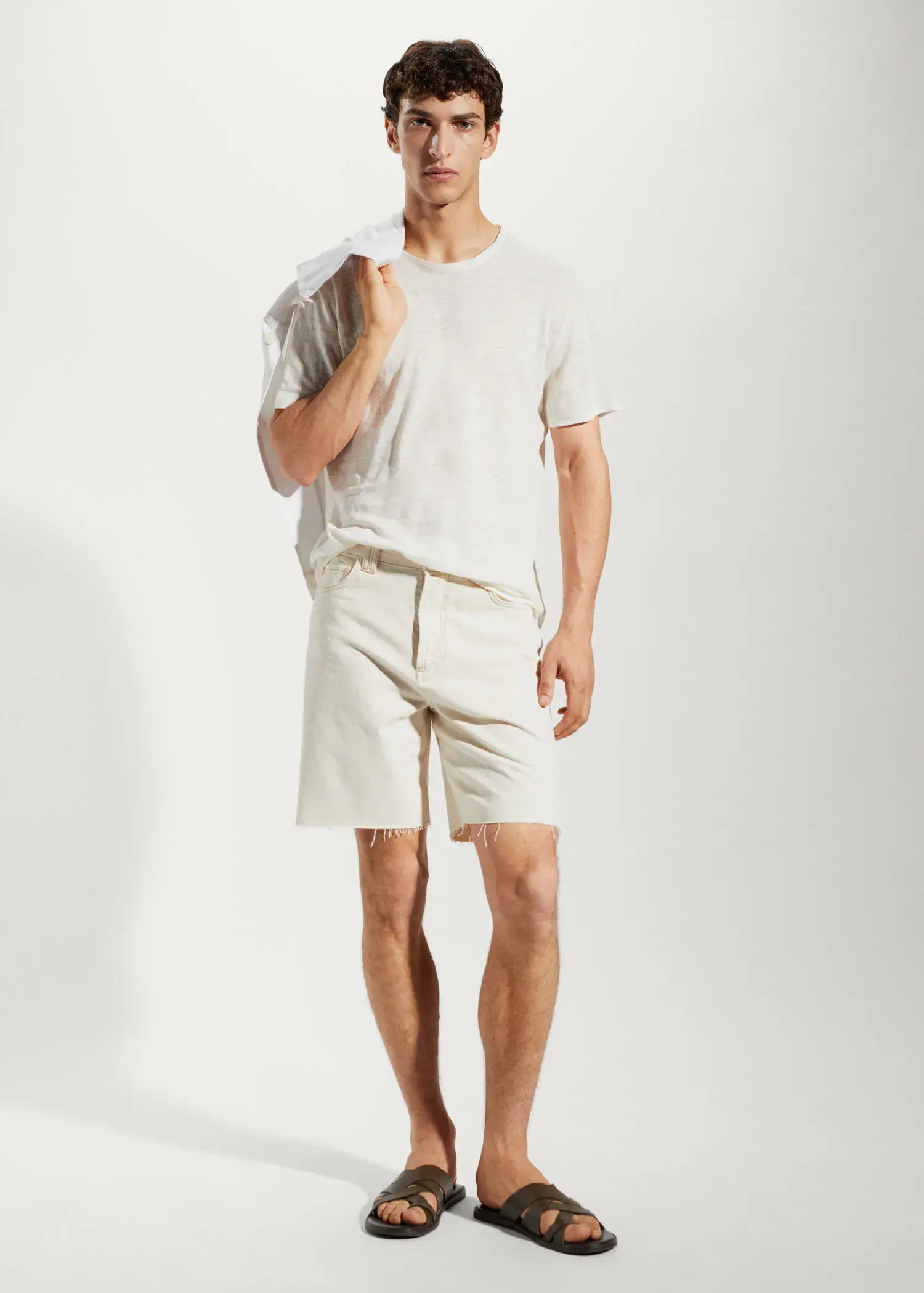Mango 100% linen slim-fit t-shirt. a man in white shirt and shorts holding a towel. 