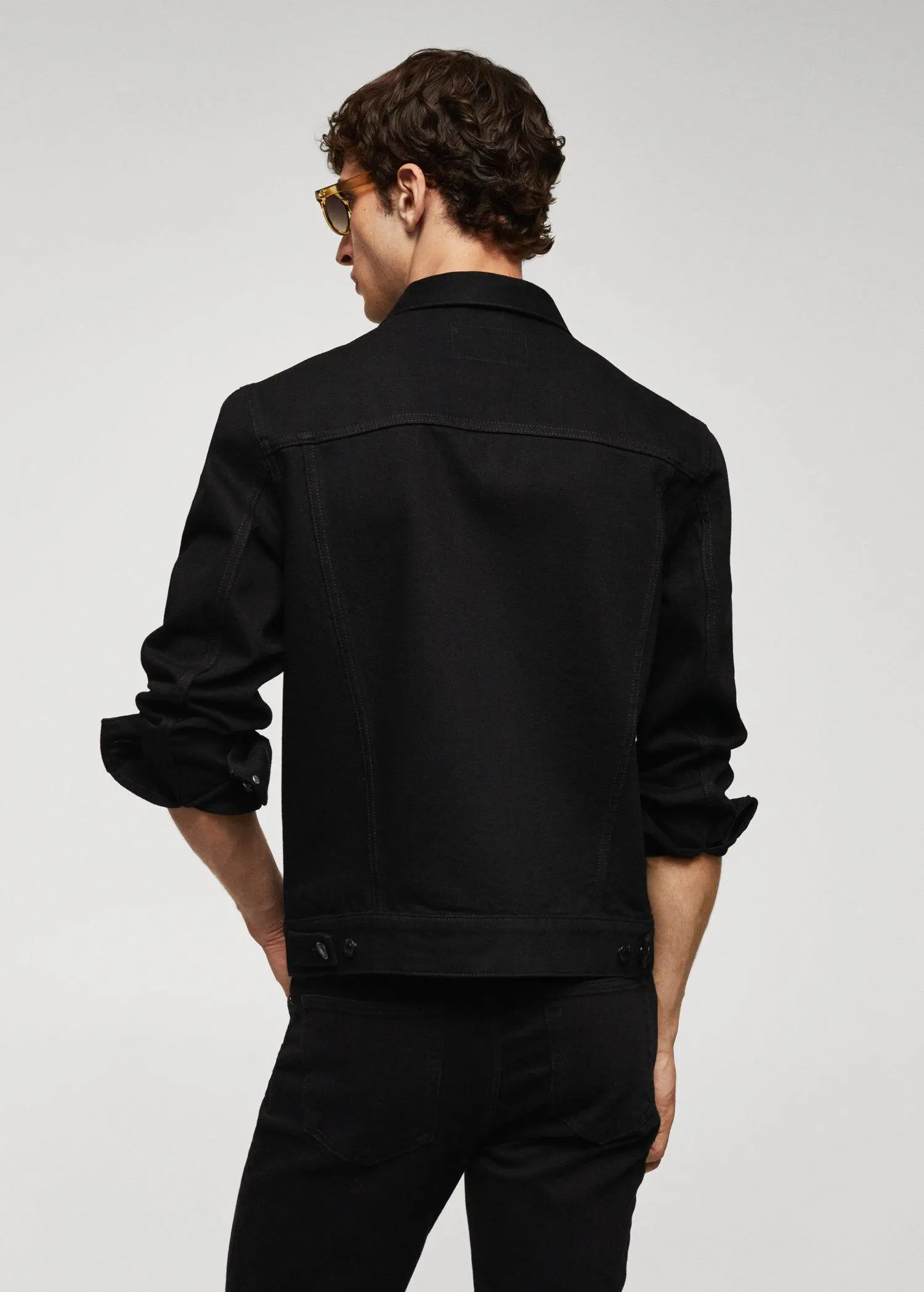 Mango Basic denim jacket. a man wearing a black jacket and black pants. 
