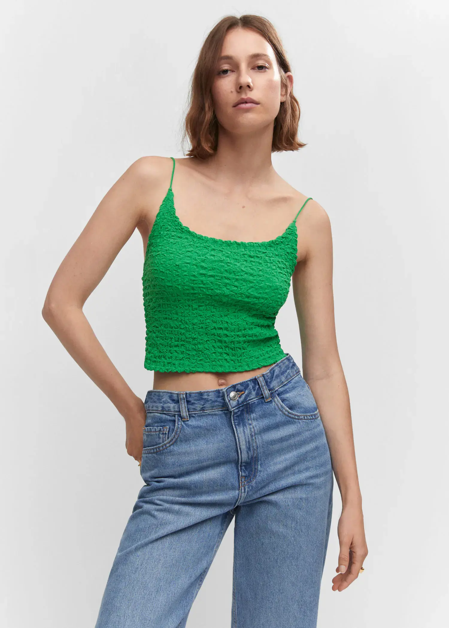 Mango Textured crop top. a woman wearing a green top and jeans. 