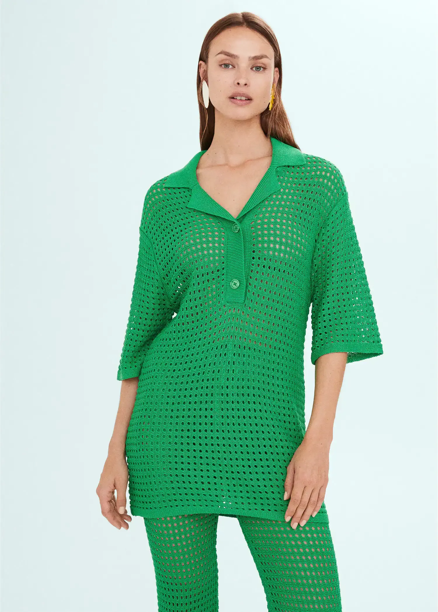 Mango Oversized openwork knitted polo shirt. a woman in a green dress is standing up 