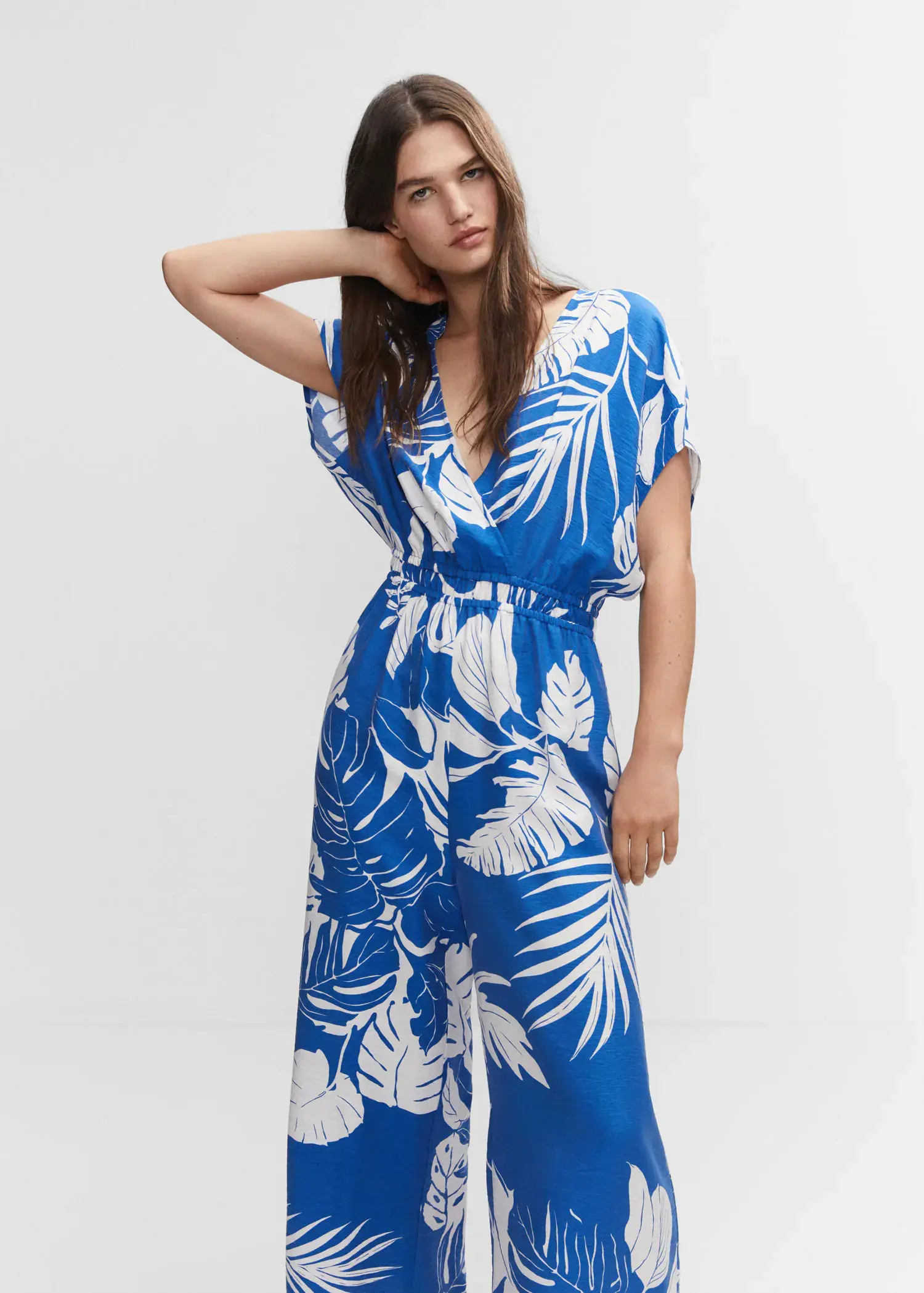 Mango Tropical print jumpsuit. a woman in a blue and white floral dress. 