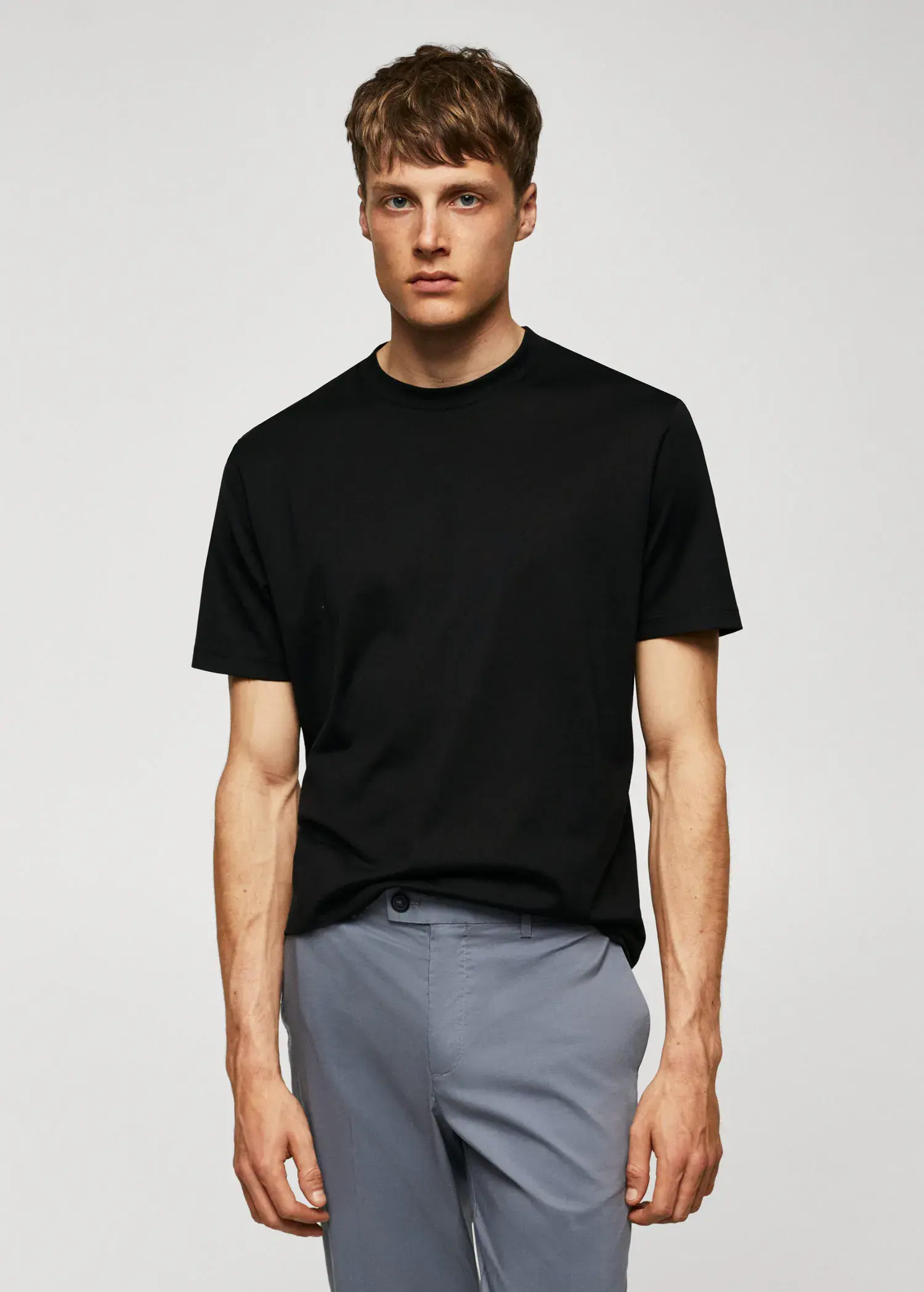 Mango Mercerised regular-fit t-shirt. a man wearing a black shirt and gray shorts. 
