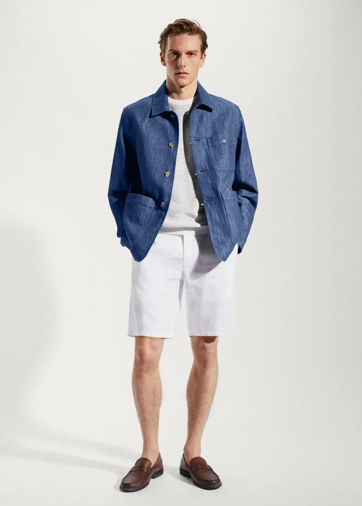 Mango Cotton-linen jacket with pockets. a man wearing a blue jacket and white shorts. 