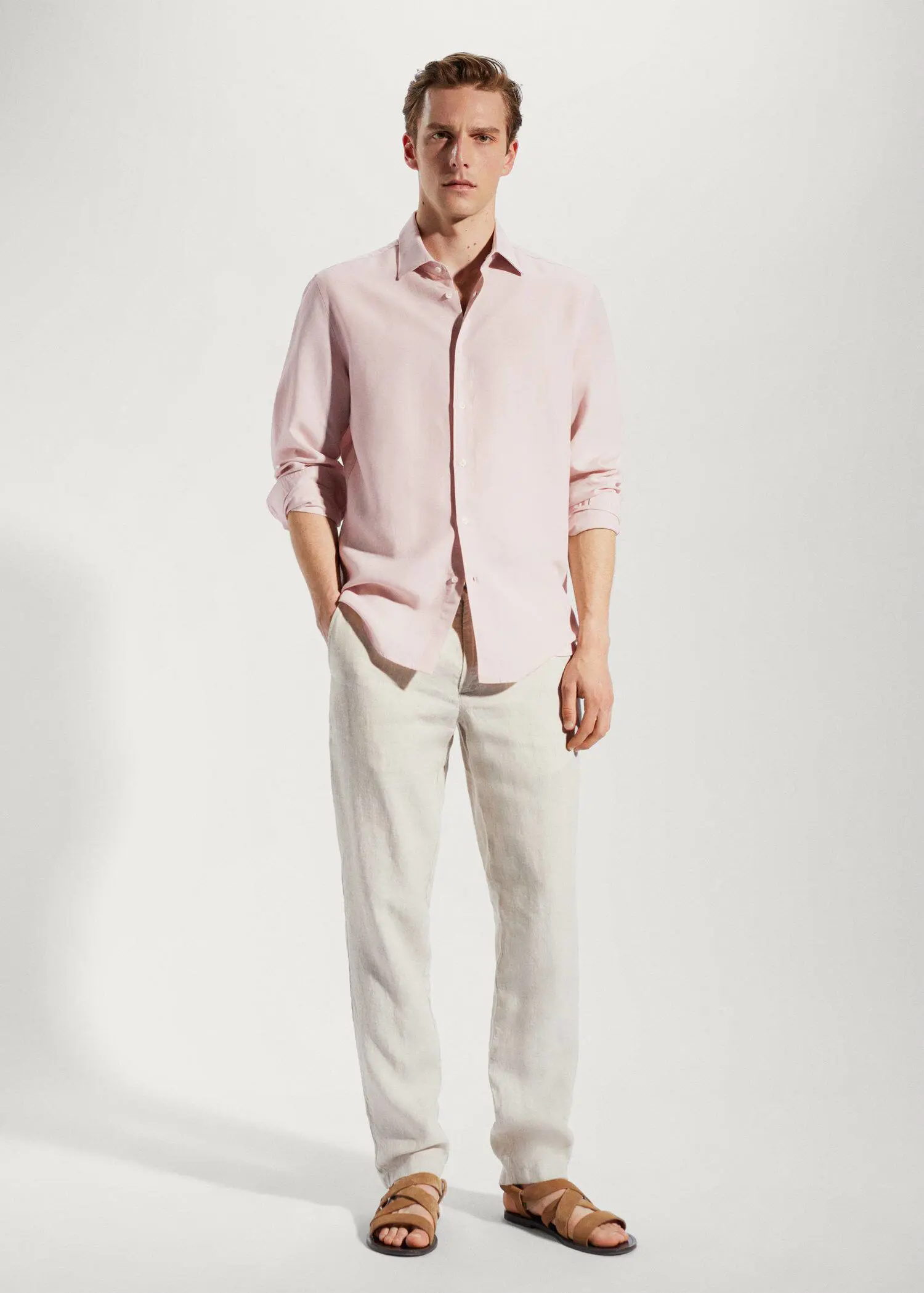 Mango Light tencel-linen shirt. a man wearing a pink shirt and white pants. 