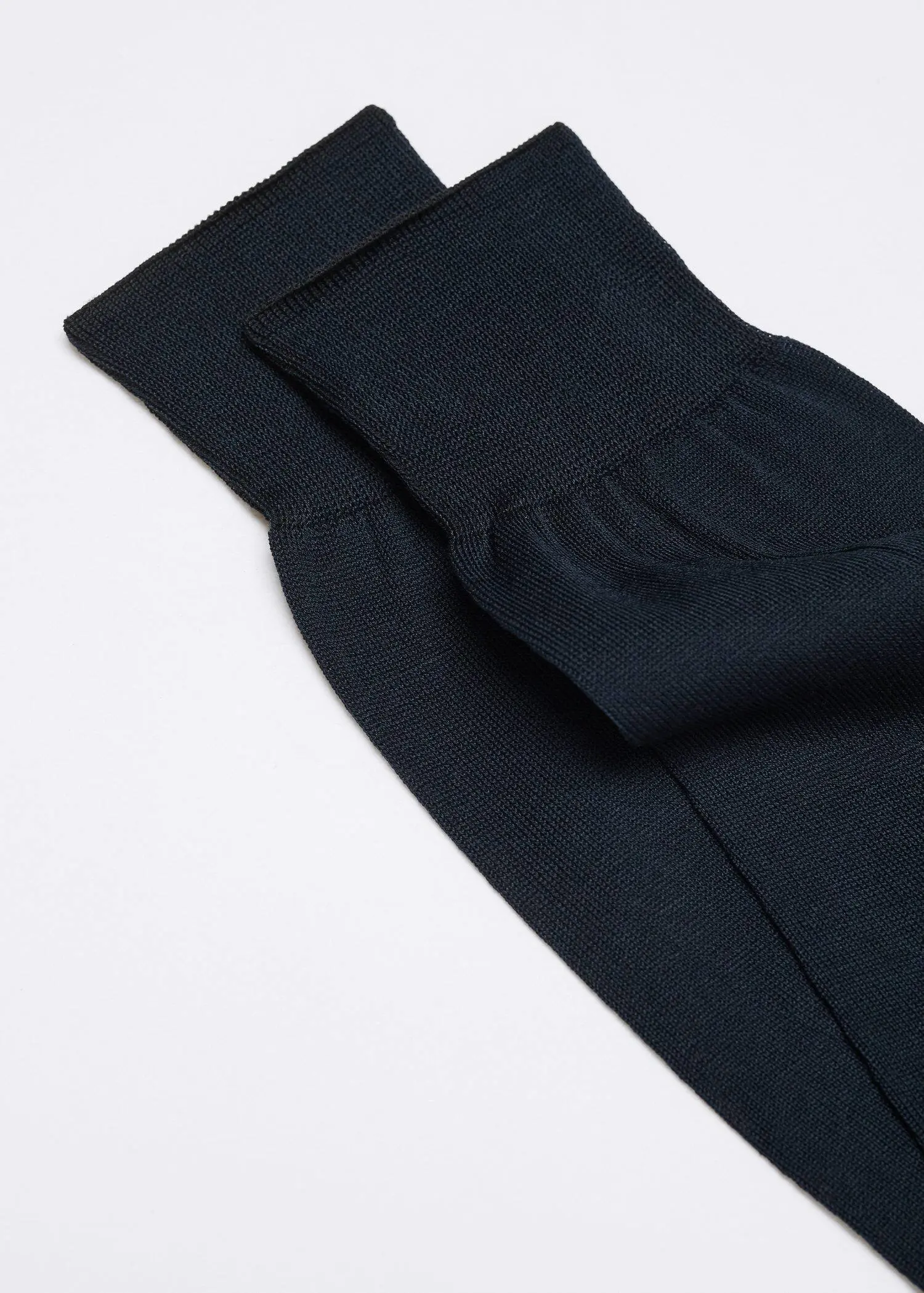 Mango 100% plain cotton socks. a close up of a pair of black socks. 