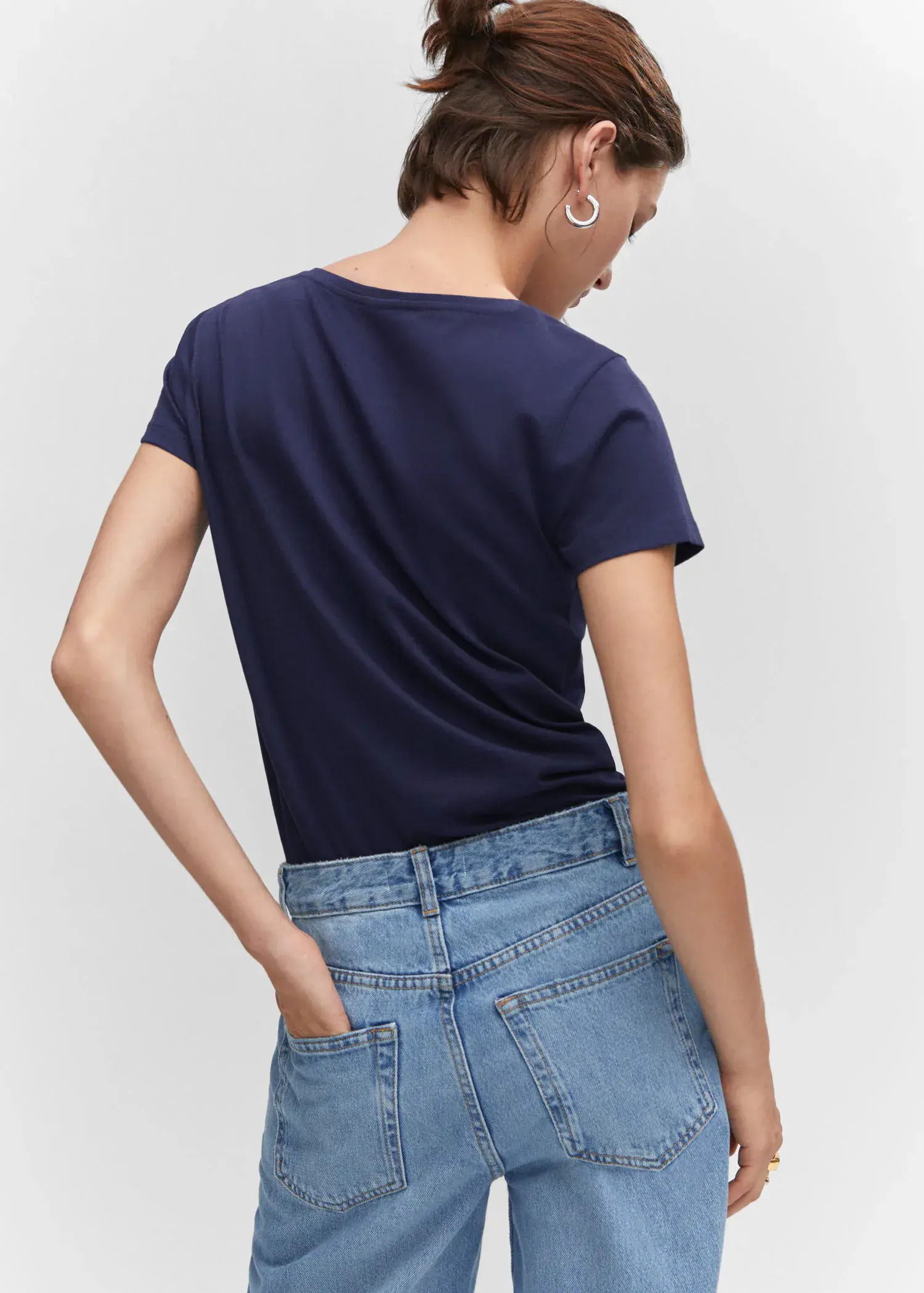 Mango Metallic logo T-shirt. a woman wearing a blue shirt and jeans. 