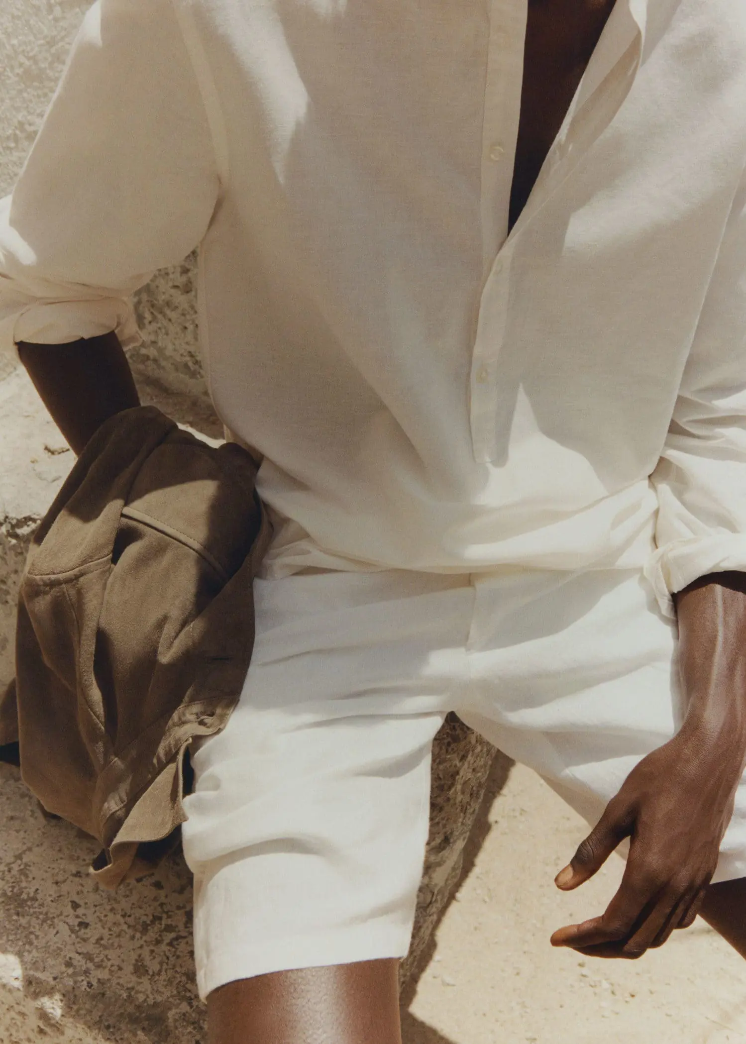 Mango Regular-fit linen shirt with mao collar. a man sitting on the ground with a backpack. 