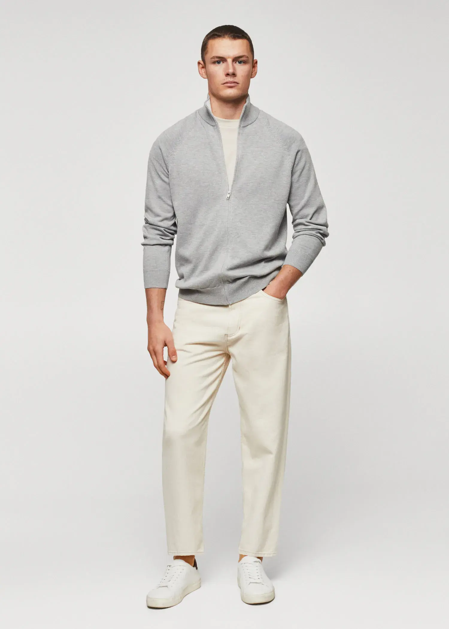 Mango Zipped cotton cardigan. a man in a gray sweater and white pants. 