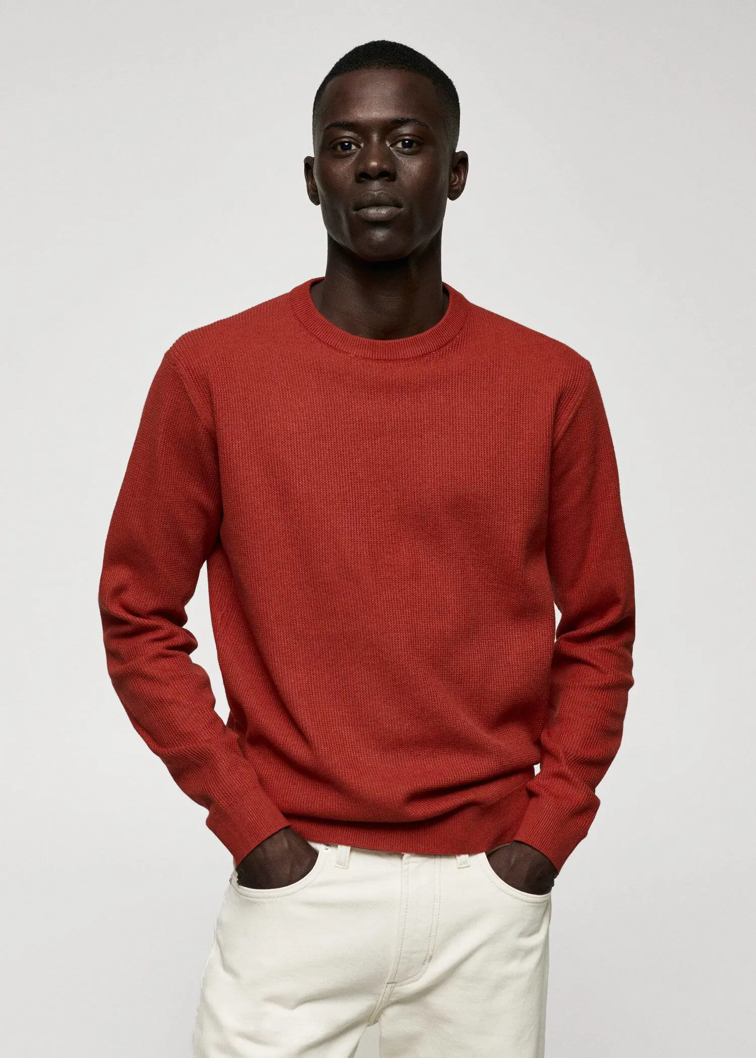 Mango Structured cotton sweater. a man in a red shirt is posing for a picture. 