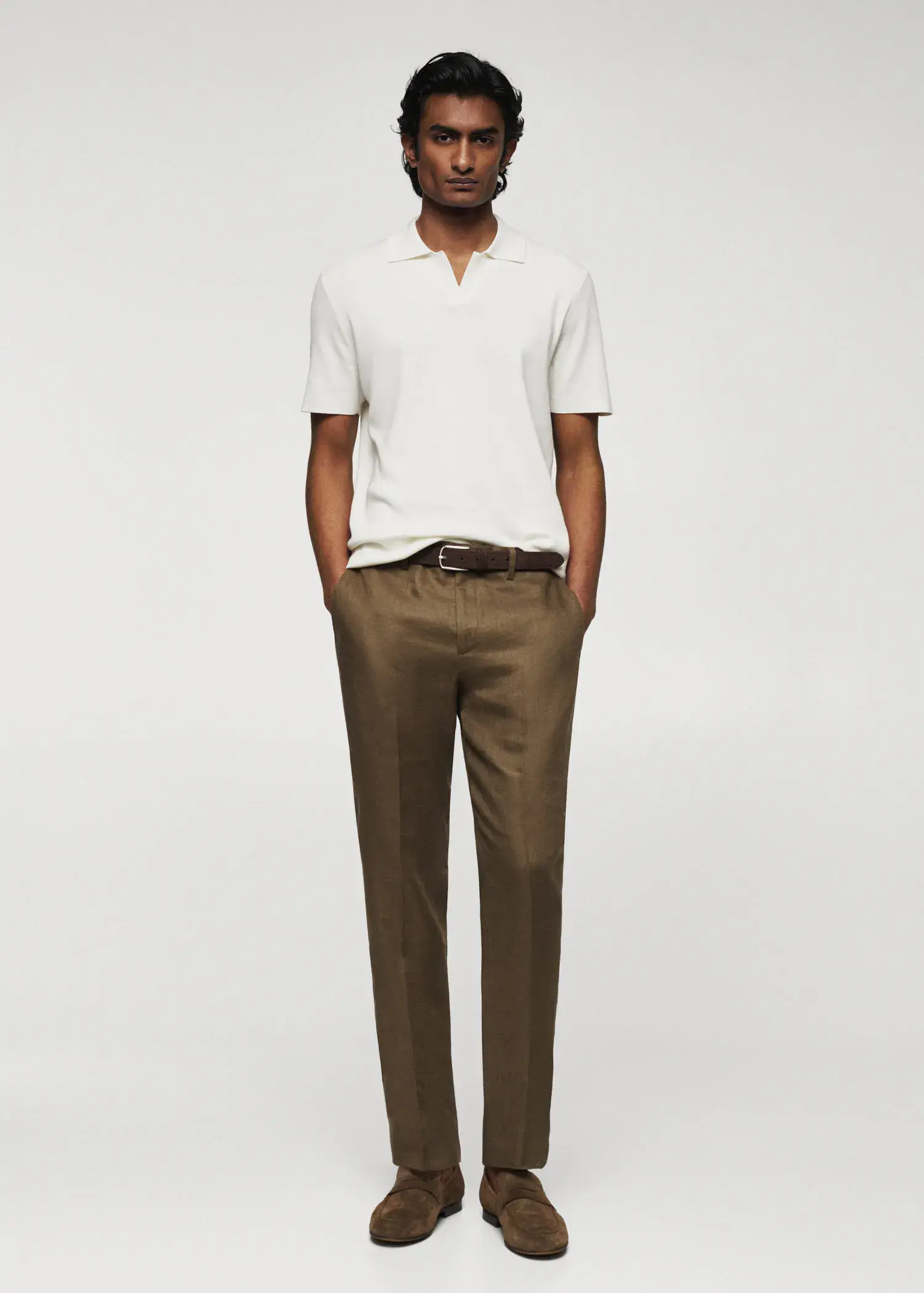 Mango Fine-knit polo shirt. a man standing in front of a white wall. 