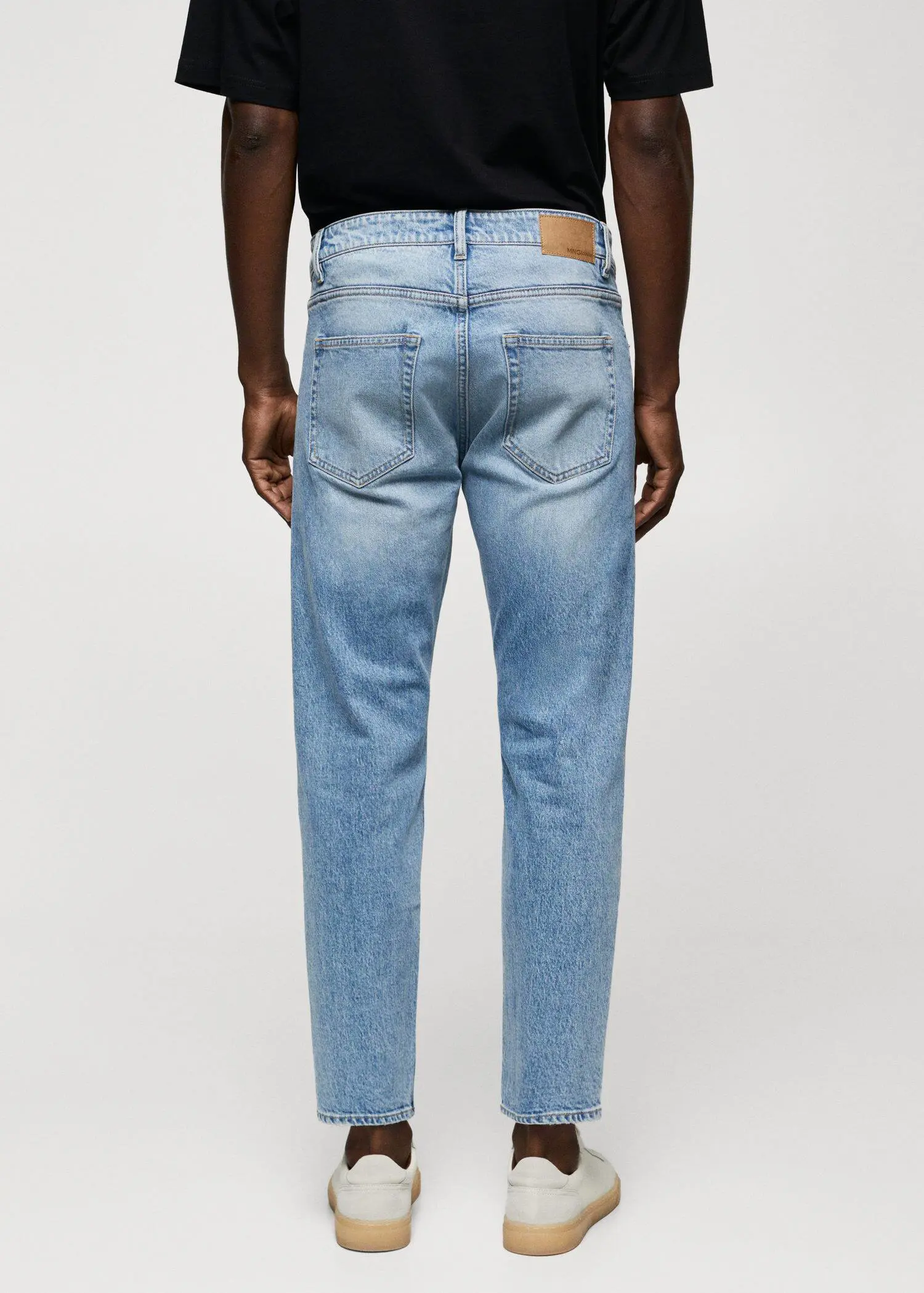 Mango Ben tapered cropped jeans. a person wearing a pair of light blue jeans. 