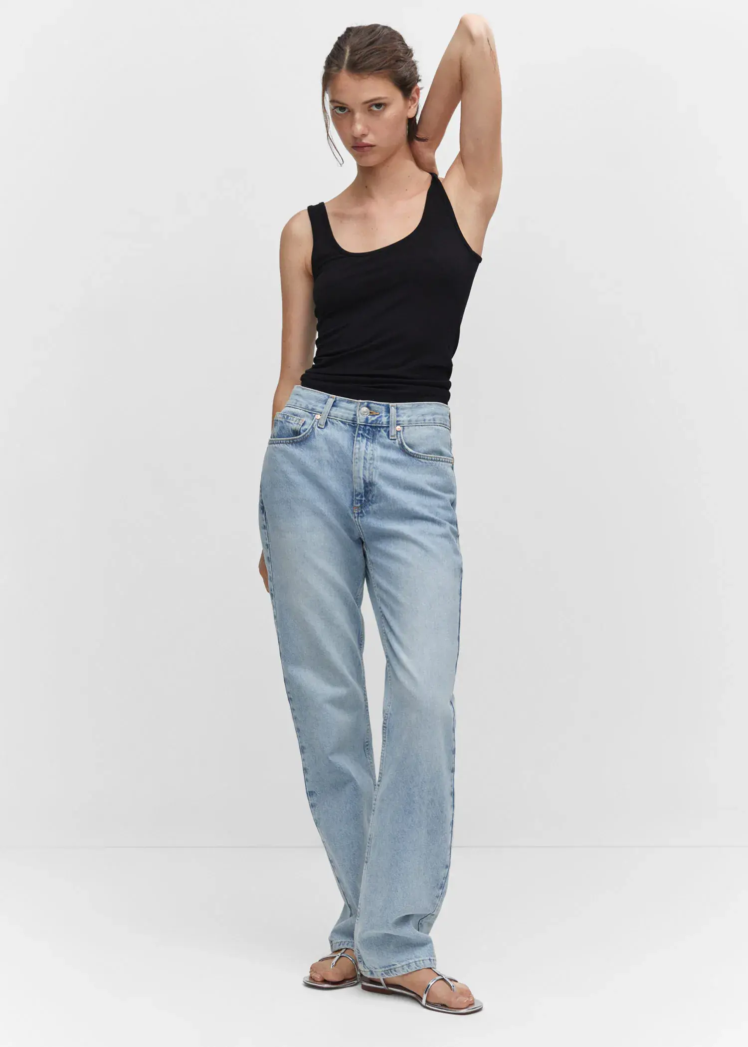 Mango Strapless halter neck top. a woman in black tank top and light blue jeans. 