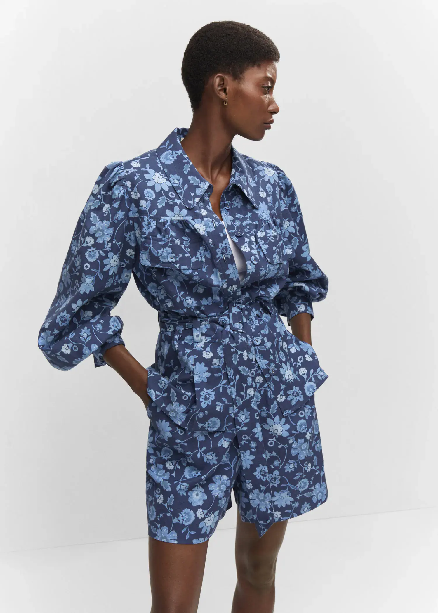 Mango Floral overshirt with belt. a woman in a blue floral print outfit. 