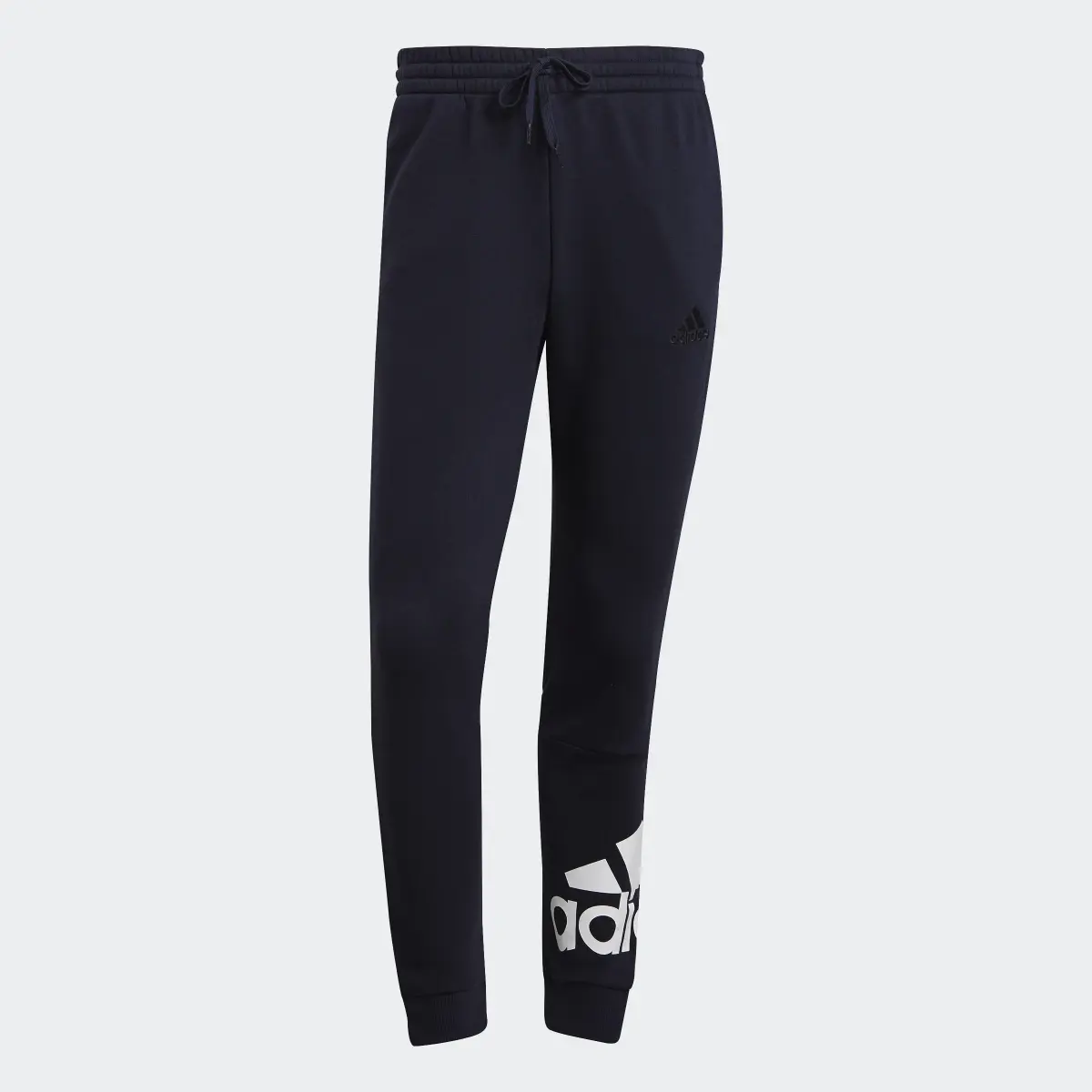 Adidas Essentials Fleece Tapered Cuff Logo Pants. 1